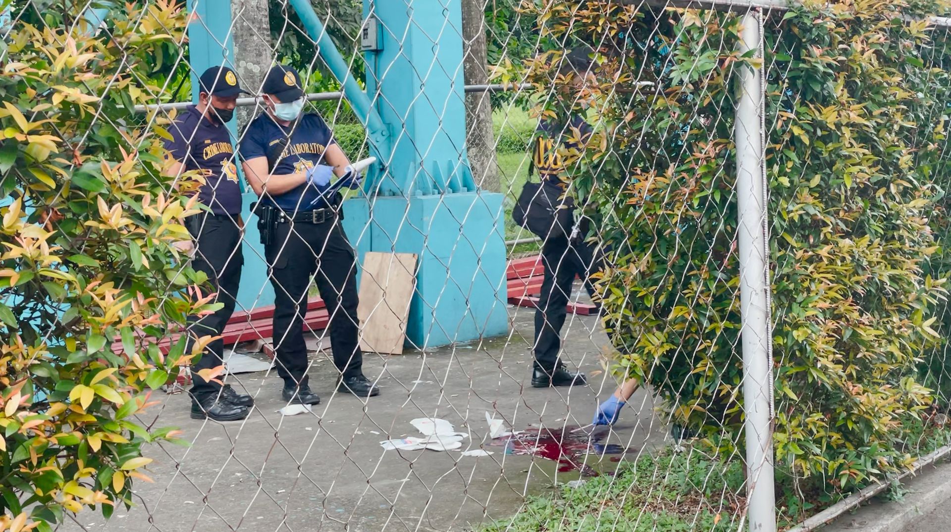 Police investigators inspect the crime scene after a shooting at the Ateneo de Manila University, in Quezon City, Metro Manila, July 24, 2022.