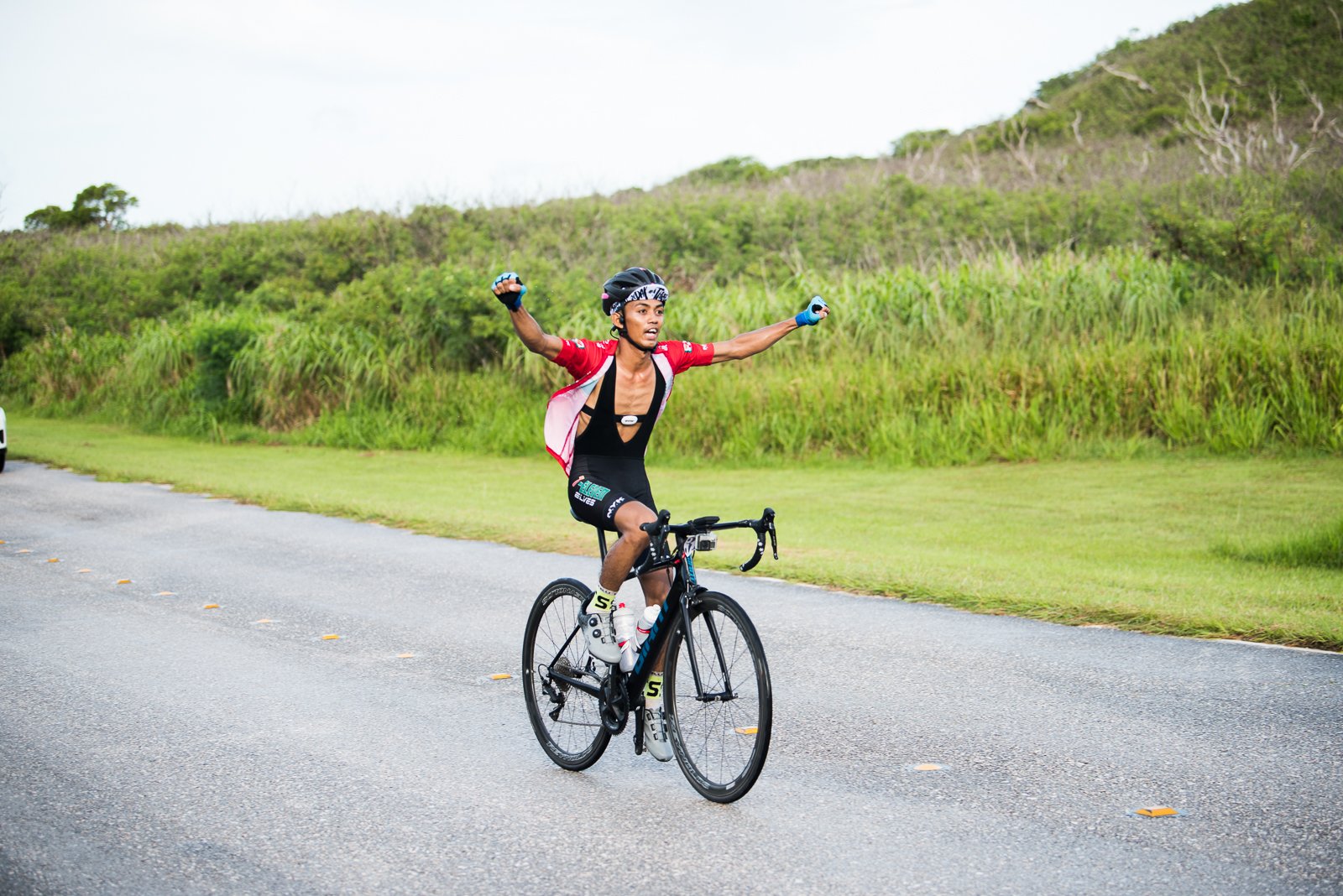 Renren Gaviola celebrates as he reaches the finish line of the 2nd Annual Bike Race For A Cause Sunday at Suicide Cliff.