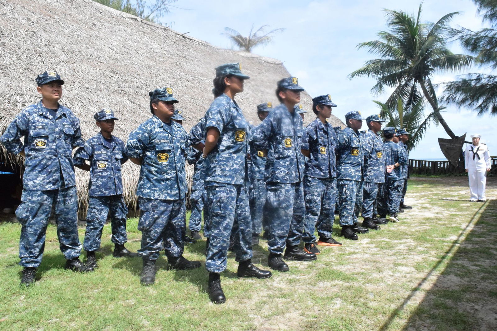The Natibu Division cadets stand at ease as Petty Officer First Class Tuyet-Lam Thai, right, looks on during the cadets’ recruit training graduation ceremony at the Guma Higai, Civic Center in Susupe on Friday.