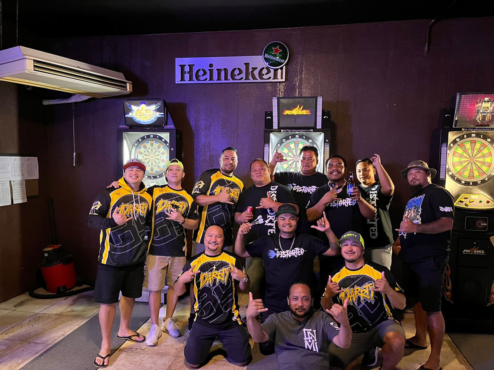 Tambayan Distorted and Jonny's Ridin Darrty pose for a photo after their match in the “A” Division of the SEDA Bud Light Dart League at the Tambayan Bar on Monday.