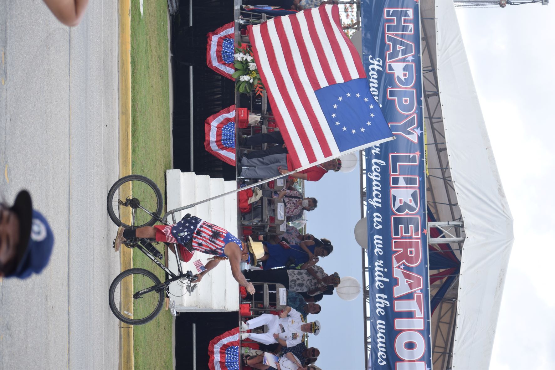 A man on his bicycle pedals pass the grandstand on Beach Road.