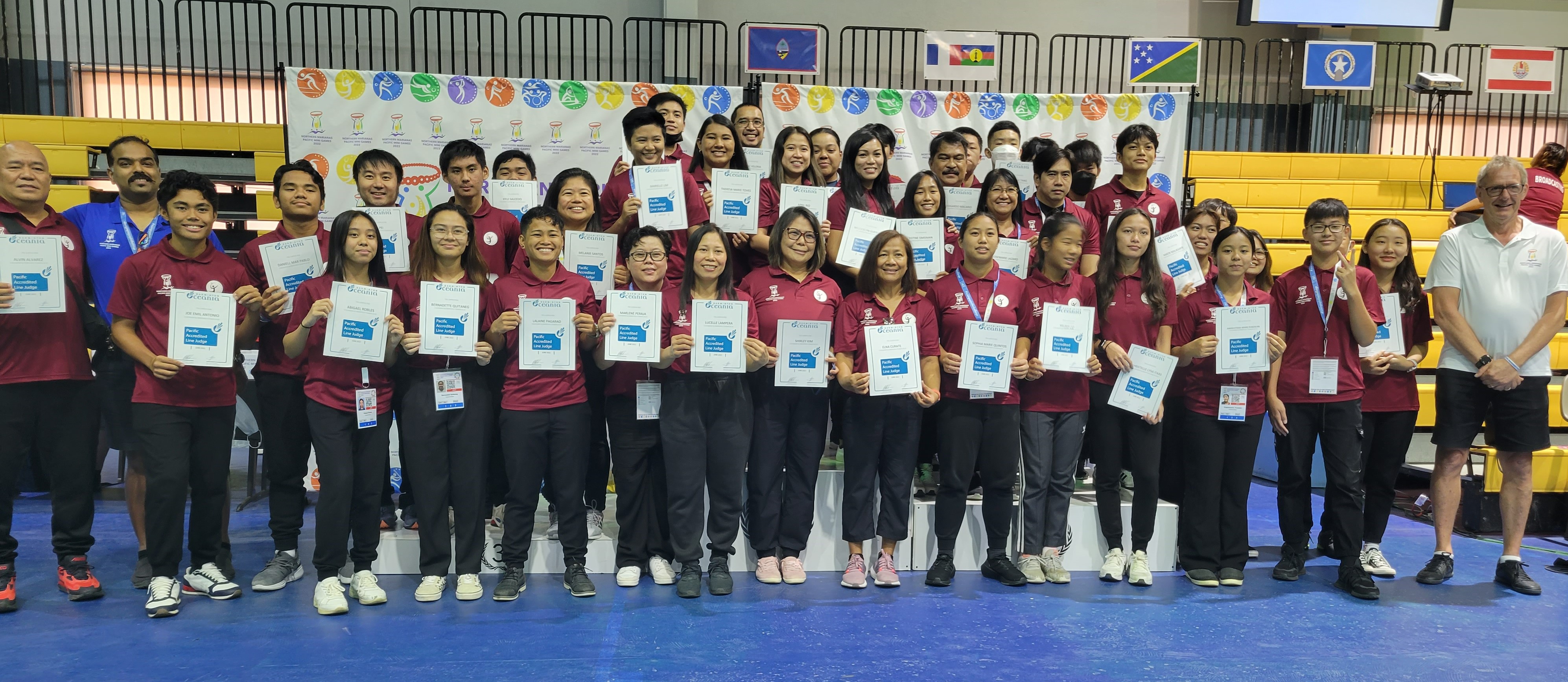 Pacific accredited line judges join Badminton World Federation line judge Ravi Nandan, second left and Badminton Oceania referee Peter Crocker, right, for a group photo during the certificate awarding ceremony in the final day of the badminton competition in the 2022 Pacific Mini Games last month at the Gilbert C. Ada Gymnasium.