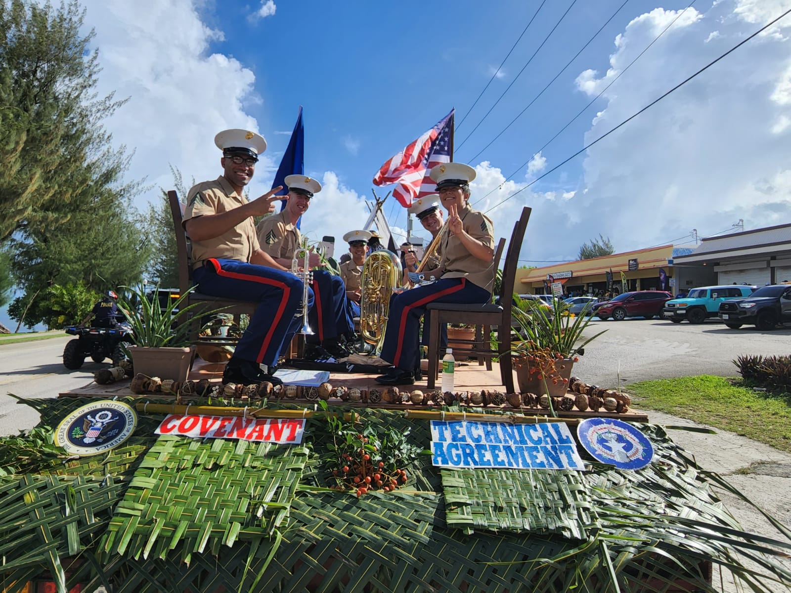 Members of the Marine Forces Pacific Band wave on the Commonwealth Bureau of Military Affairs float during the Liberation Day parade.