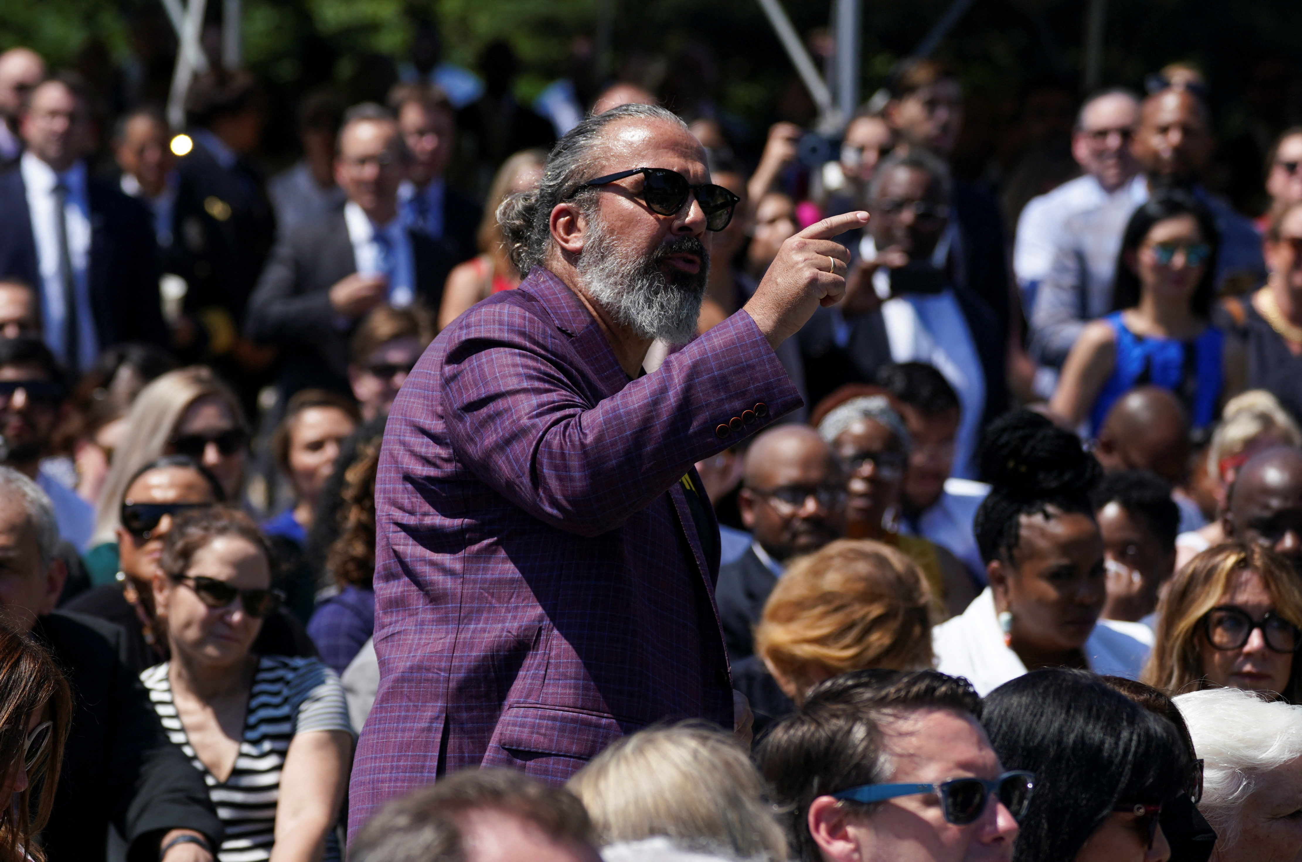 Manuel Oliver, whose son Joaquin was killed in the 2018 mass shooting at Marjory Stoneman Douglas High School in Parkland, Florida, calls for additional gun control actions as he interrupts President Joe Biden during a White House event to celebrate passage of the "Safer Communities Act," in Washington, D.C., July 11, 2022.