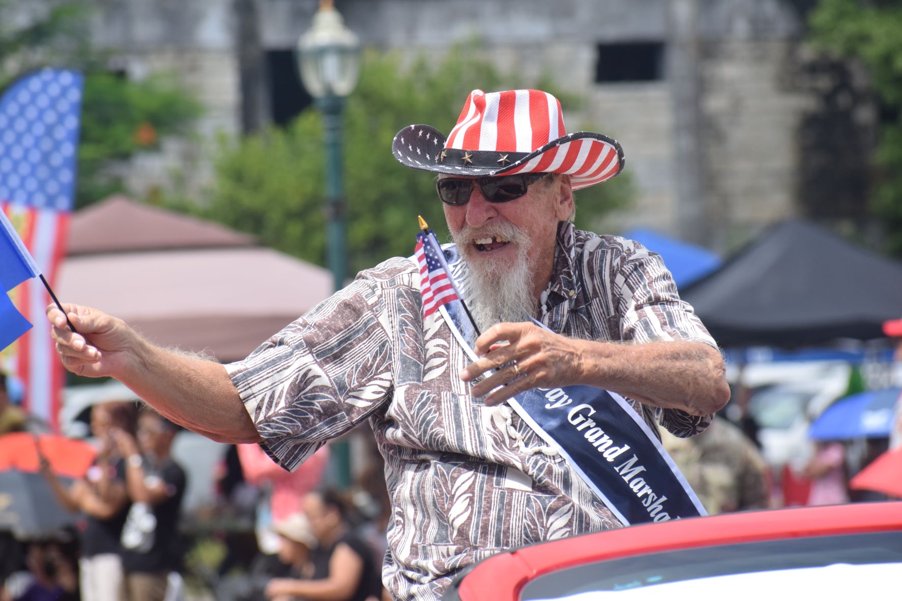 2021 grand marshal and NMI historian Don Farrell acknowledges the cheering crowd.