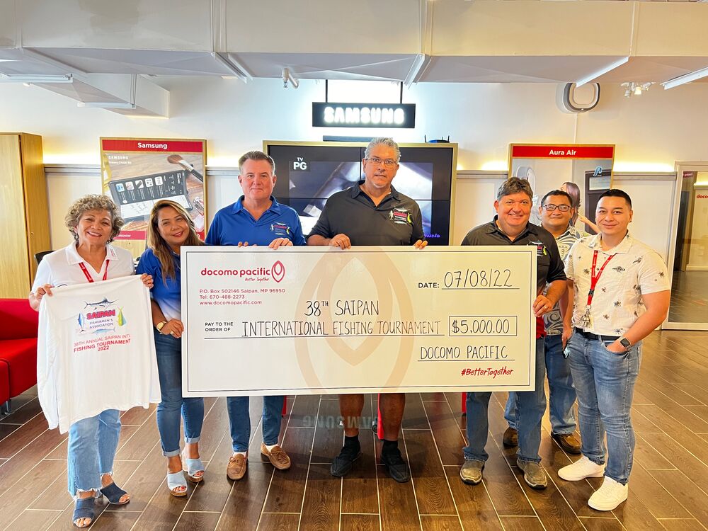 Saipan International Fishing Tournament check presentation. From left, Pauline Johnson, General Manager, Docomo Pacific; Mira Schular, Secretary, Saipan Fishermen’s Association; Schott Schular, Vice President, SFA; Curtis Dancoe, Solicitation Chair, SFA; Tony Scragg, President, SFA; Floyd Masga, Social Media Coordinator, SFA; and Brent Deleon Guerrero, CNMI Brand Manager, Docomo Pacific.