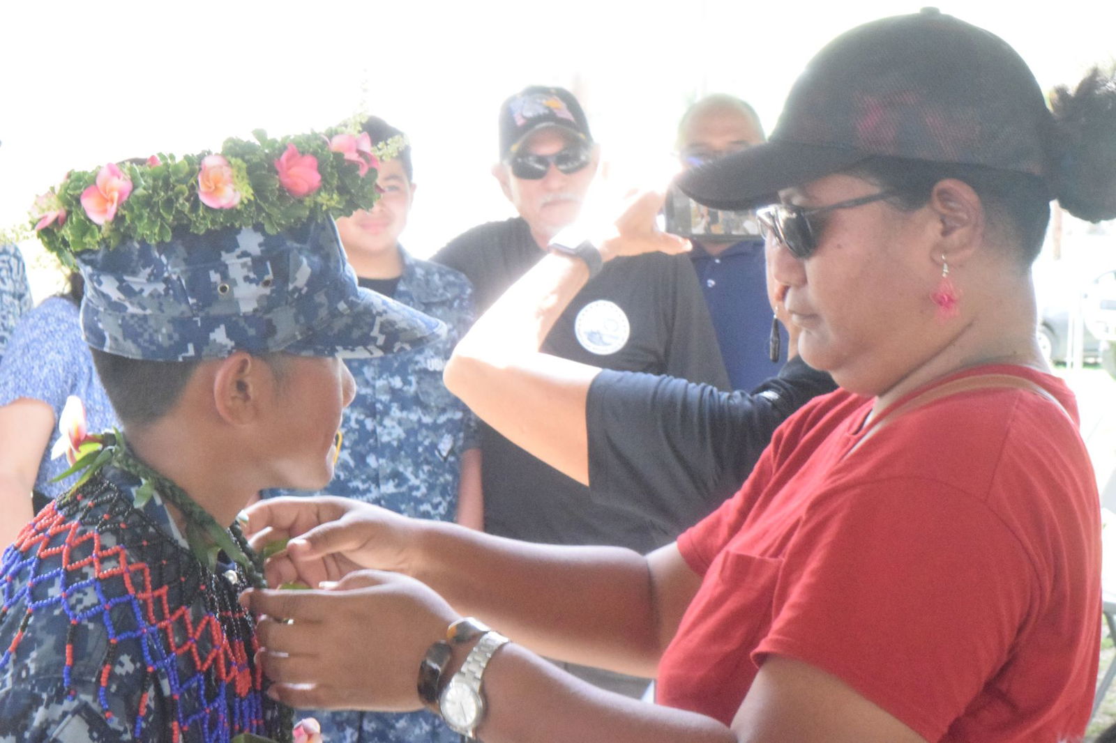 Trinidad Pangelinan, right, puts a lei on his son, Navy League Cadet Michael Joe Pangelinan.