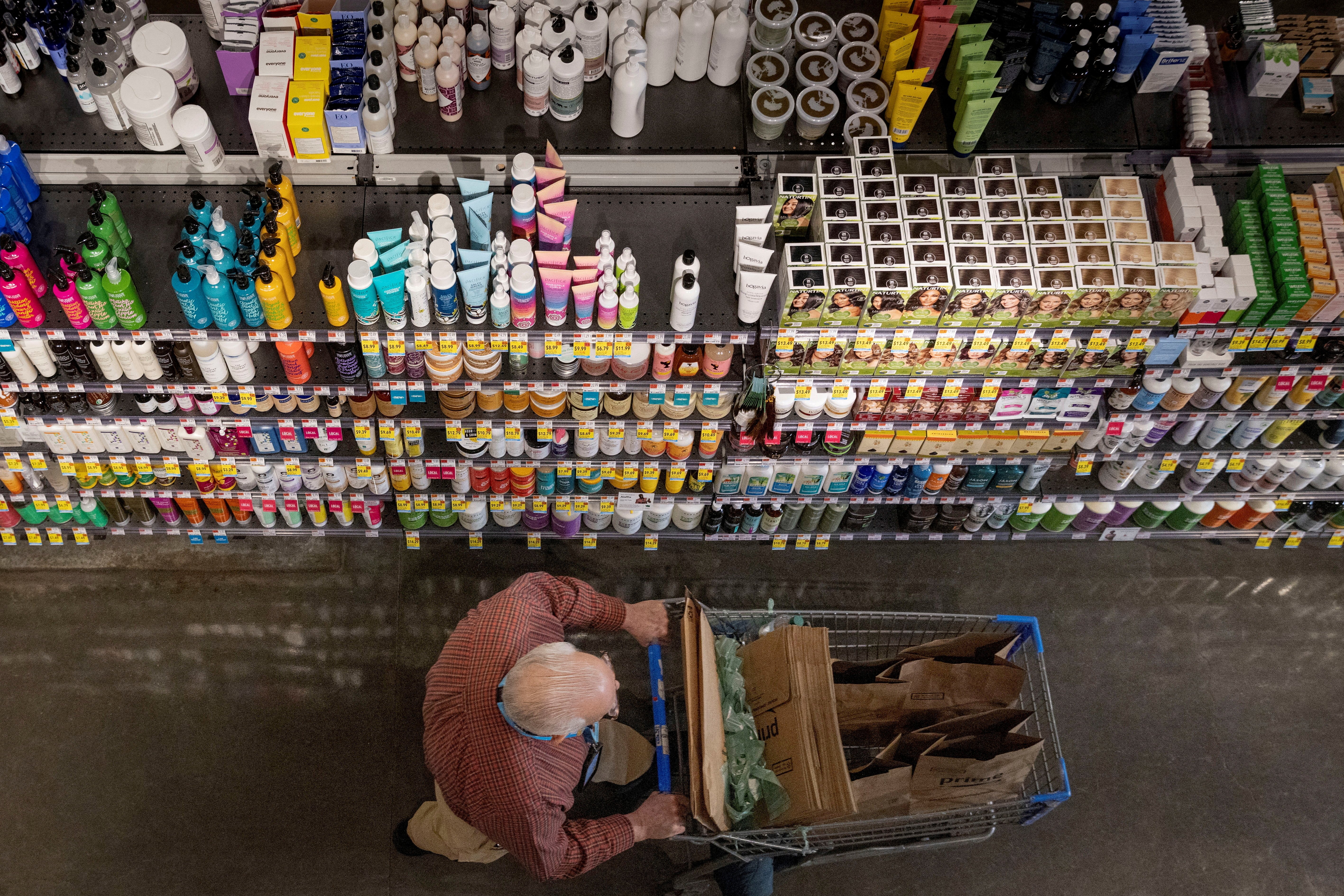 A person pushes a shopping cart in a supermarket in Manhattan, New York City, March 28, 2022.
