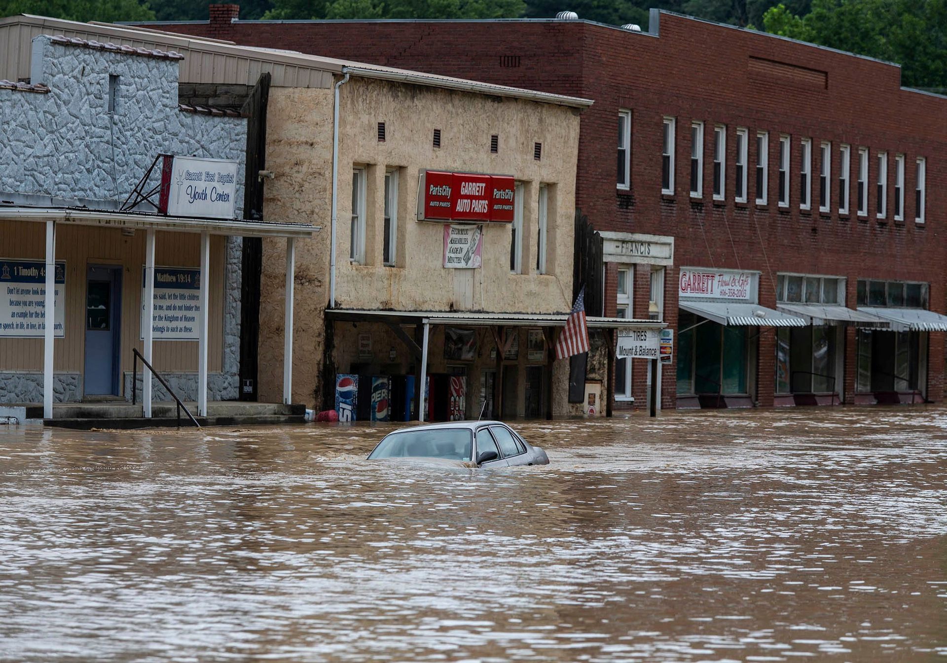 A car is submerged in flood waters along Right Beaver Creek, following a day of heavy rain in in Garrett, Kentucky, July 28, 2022.