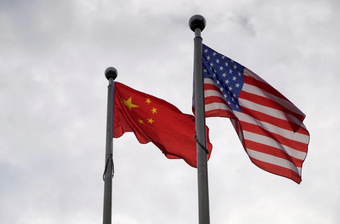 Chinese and U.S. flags flutter outside a company building in Shanghai, China, Nov. 16, 2021.