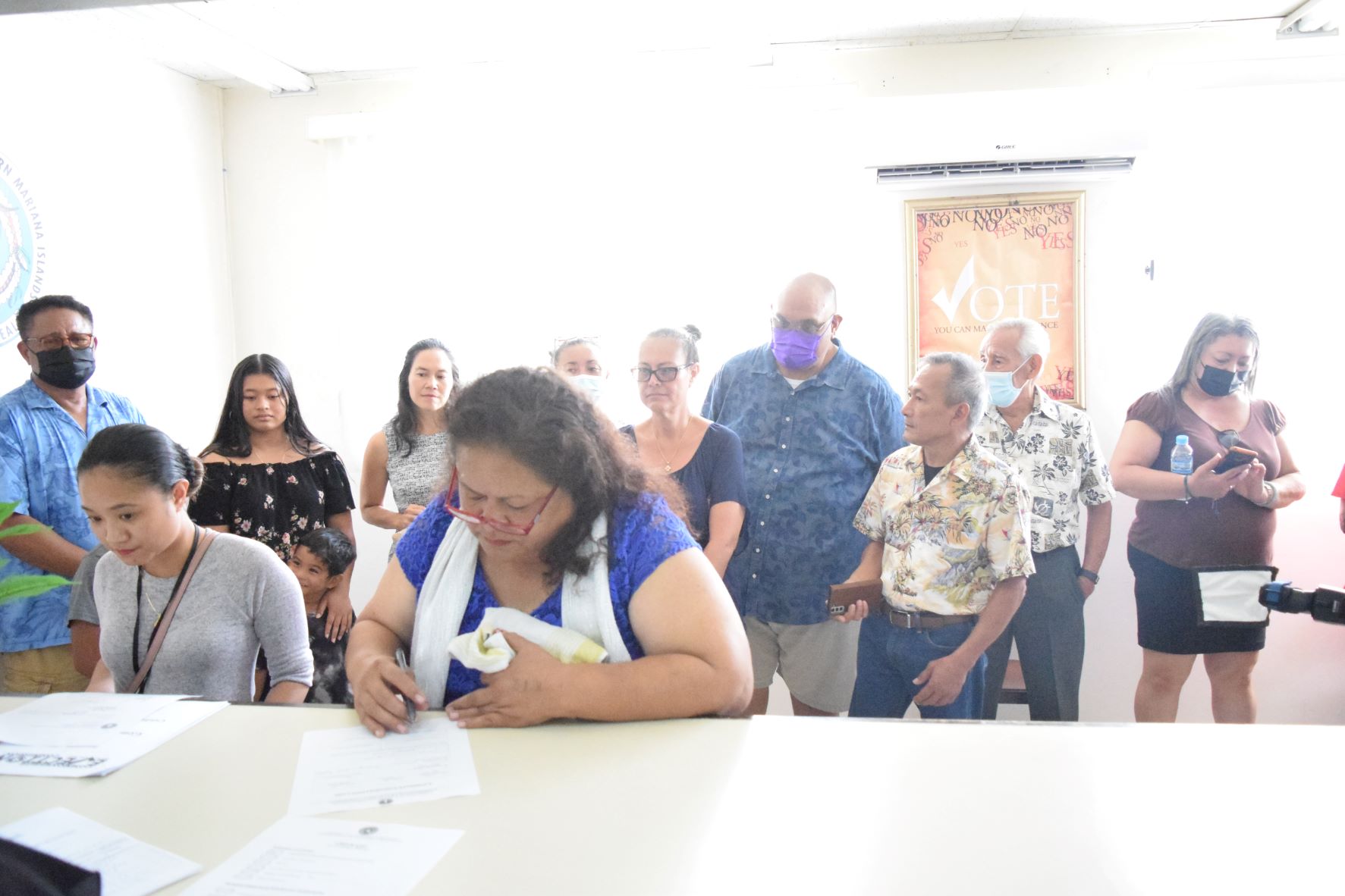 Rep. Denita Yangetmai fills out a form at the Commonwealth Election Commission. With her are her husband, former Yap Lt. Gov. James Yangetmai, left, NMI Democratic Party gubernatorial candidate Rep. Tina Sablan, fourth left, NMI Democratic Party President Jonathan Cabrera, third right, Precinct 3 Rep. Vicente Camacho, second right, and former Gov. Carlos S. Camacho.