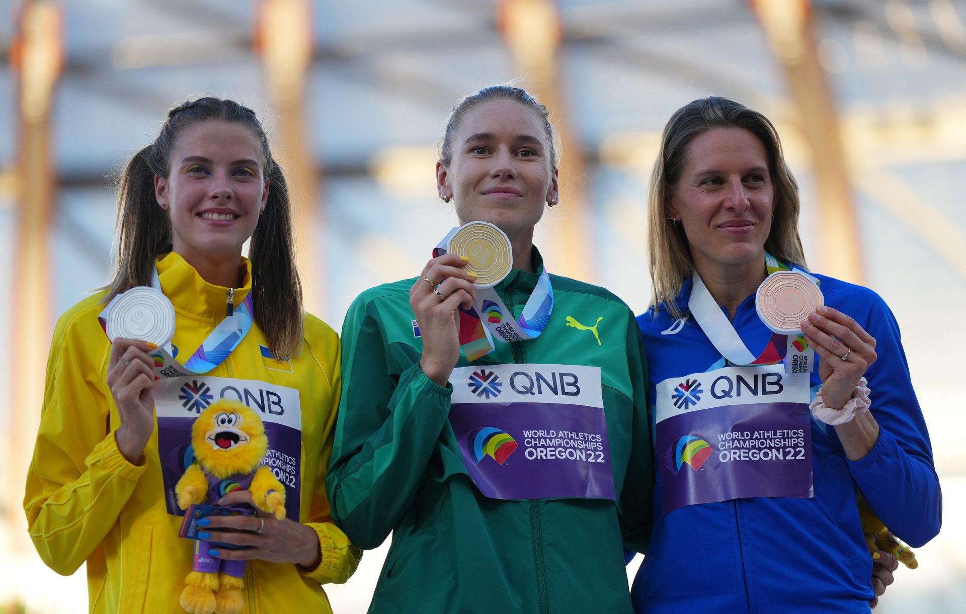 Gold medalist Eleanor Patterson of Australia celebrates on the podium alongside silver medalist Yaroslava Mahuchikh of Ukraine and bronze medalist  Elena Vallortigara of Italy during the medal ceremony at the Hayward Field in Eugene, Oregon, July 19, 2022.