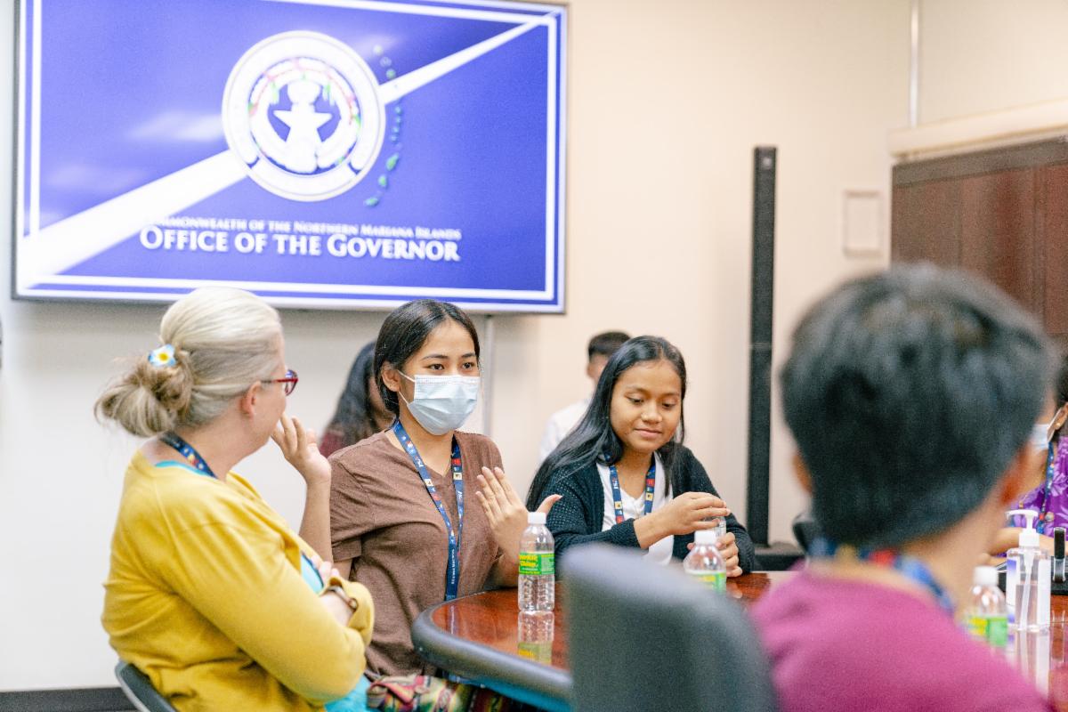 Gwyneth Danis, center, from Our Lady of Mercy Catholic High School in the Federated States of Micronesia, asks CNMI Gov. Ralph DLG Torres —  not in photo — a question at his office.