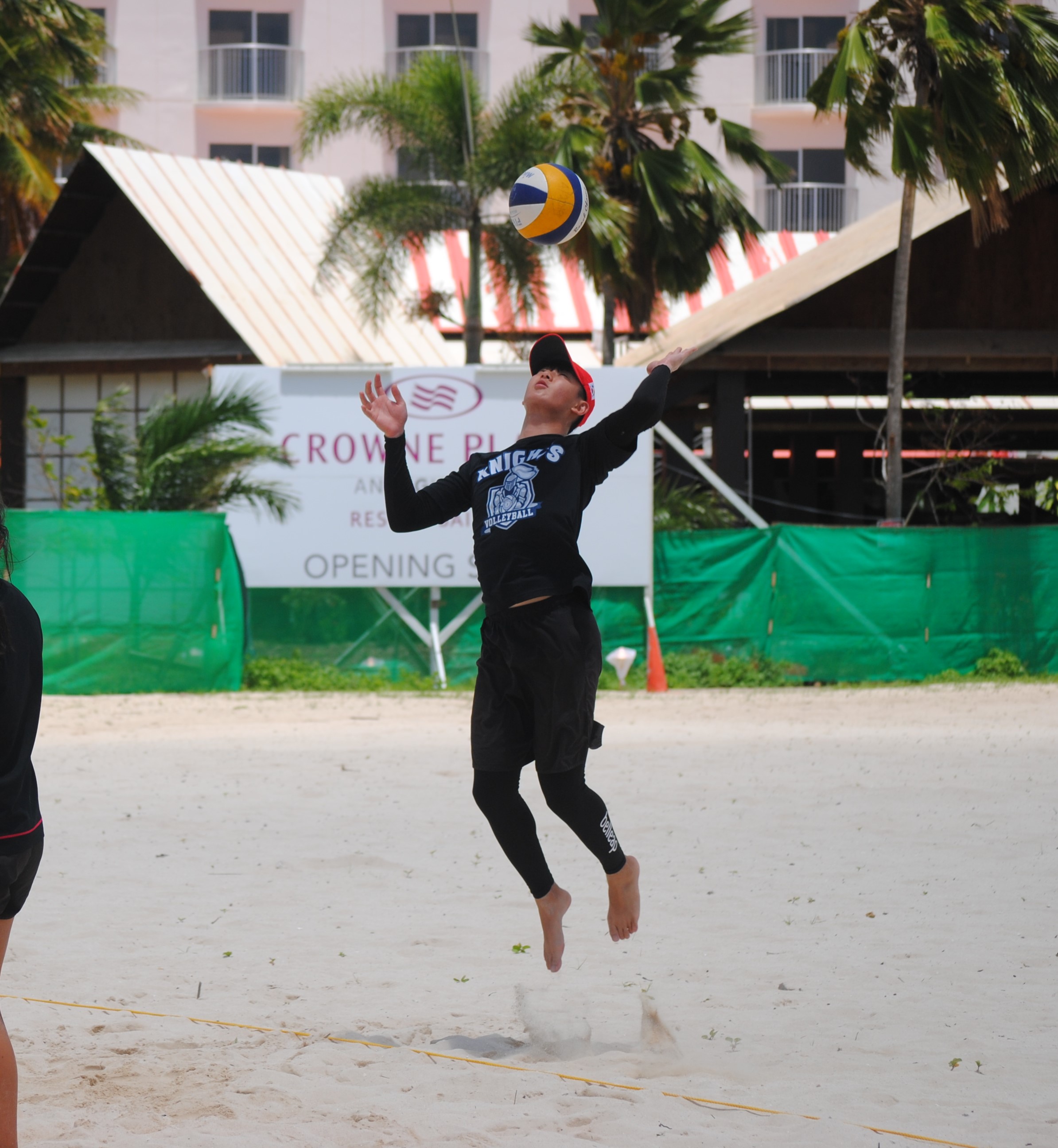 Sam Ryu leaps for the overhead serve.