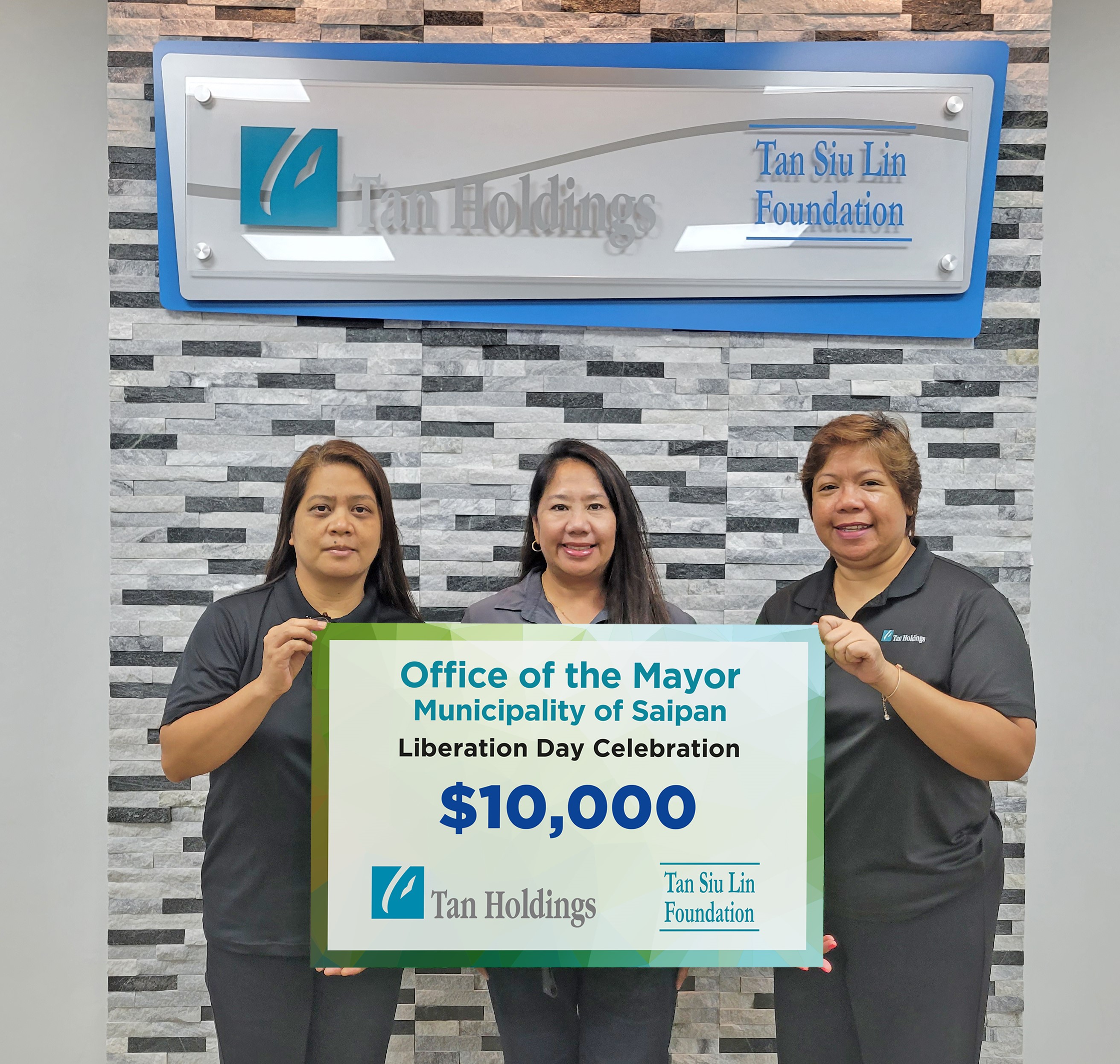 Saipan Mayor’s Office field operations director Joann Aquino, center, receives the ceremonial check donation for the Liberation Day festivities from TanHoldings executive Judy Mendieta, right, and Tan Siu Lin Foundation administrative officer Rina Robles during a turnover ceremony last week in Garapan.