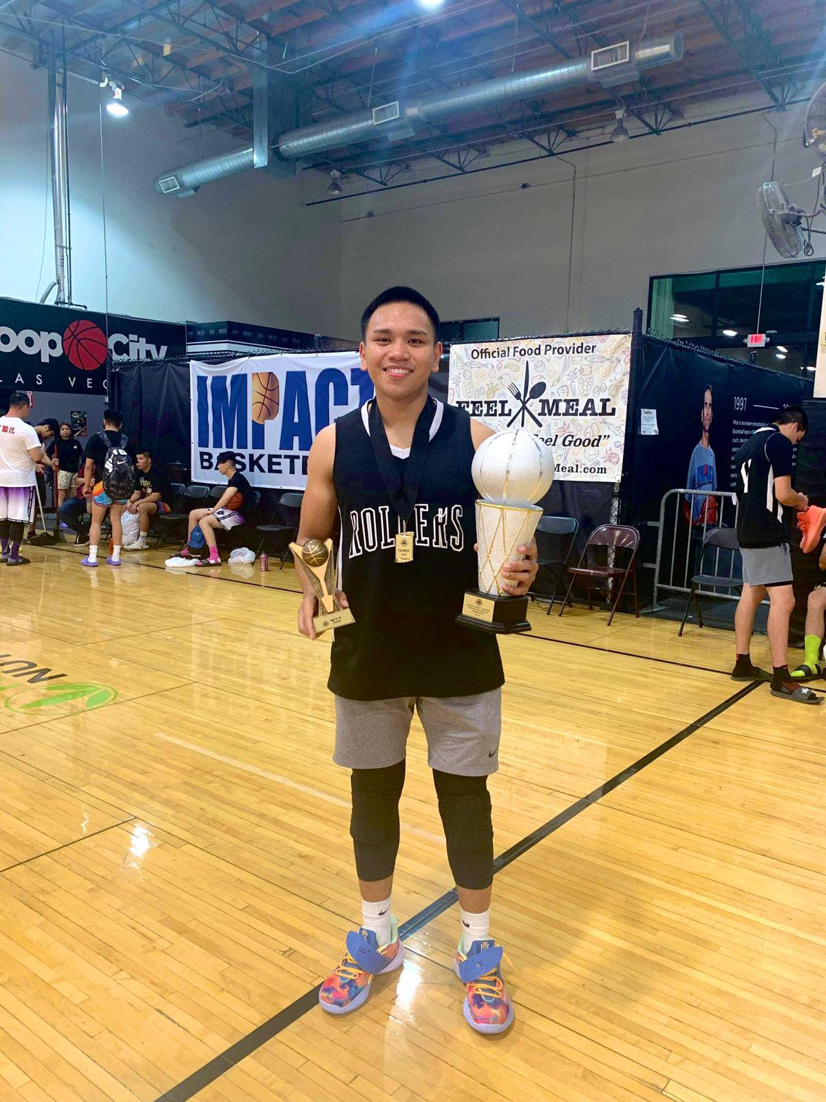 Rollers' June Alipio poses with the MVP trophy.