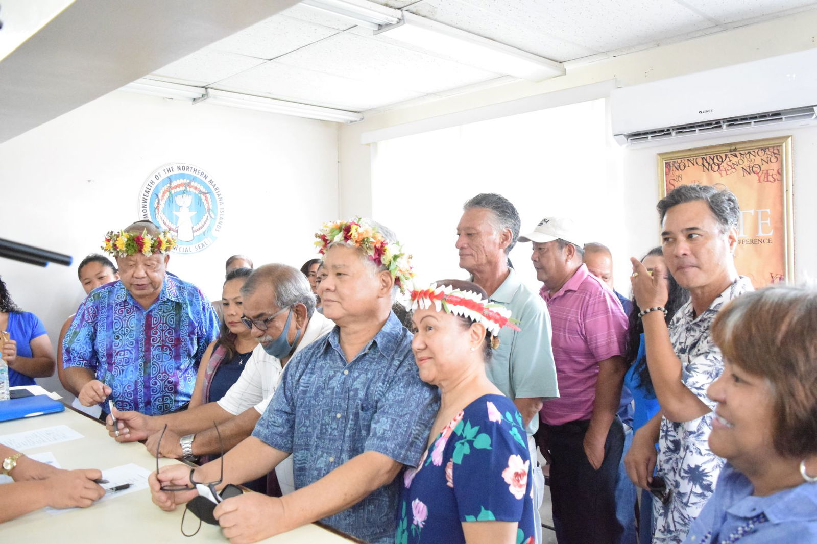 Independent gubernatorial candidate Lt. Gov. Arnold I. Palacios, center, and his running mate, Saipan Mayor David M. Apatang, second left, are accompanied by Arnold-Dave 2022 team campaign chairman, former Speaker Oscar M. Babauta, fourth left, and other supporters as they file their candidacies at the Commonwealth Election Commission on Friday. Also in the photo are Palacios's wife, Wella, his brothers Mark and Alex, and former Special Assistant for Management and Budget Vicky Villagomez.