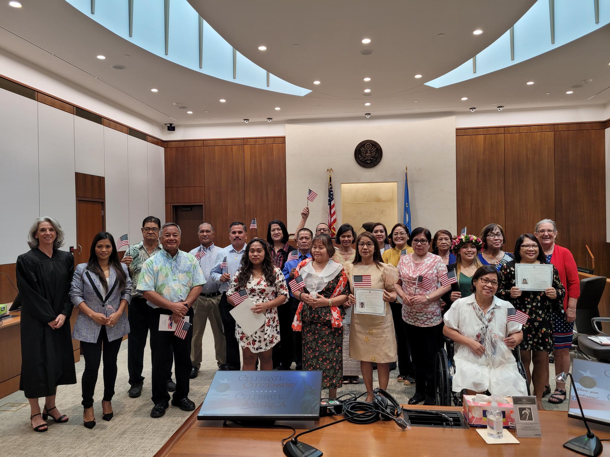 Nineteen new U.S. citizens were sworn in on Tuesday by Magistrate Judge Heather Kennedy of the District Court for the NMI. Also in the  photo are Michael Sablan, civilian aide to the U.S. Secretary of the Army for the CNMI, and Patricia Phelan, U.S. Citizenship and Immigrations Services officer.