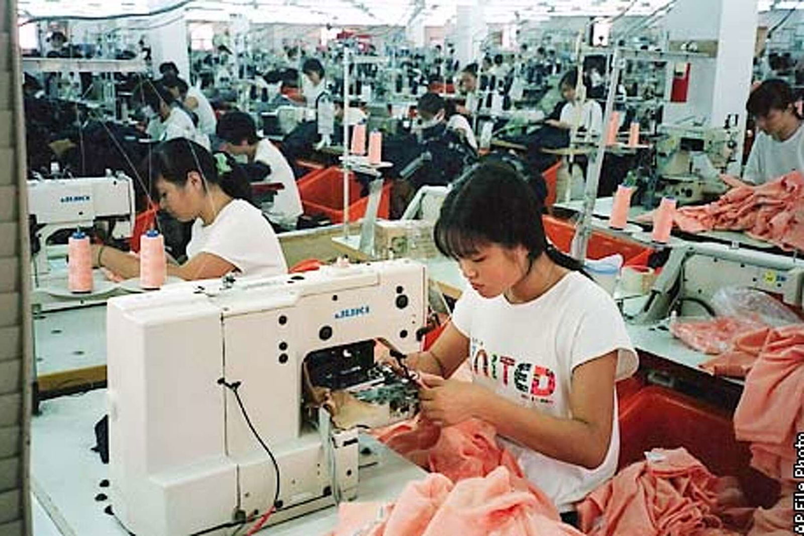 Workers at their sewing machines on the main assembly floor of the United International Corp garment plant in Saipan, Dec. 15, 1997.  