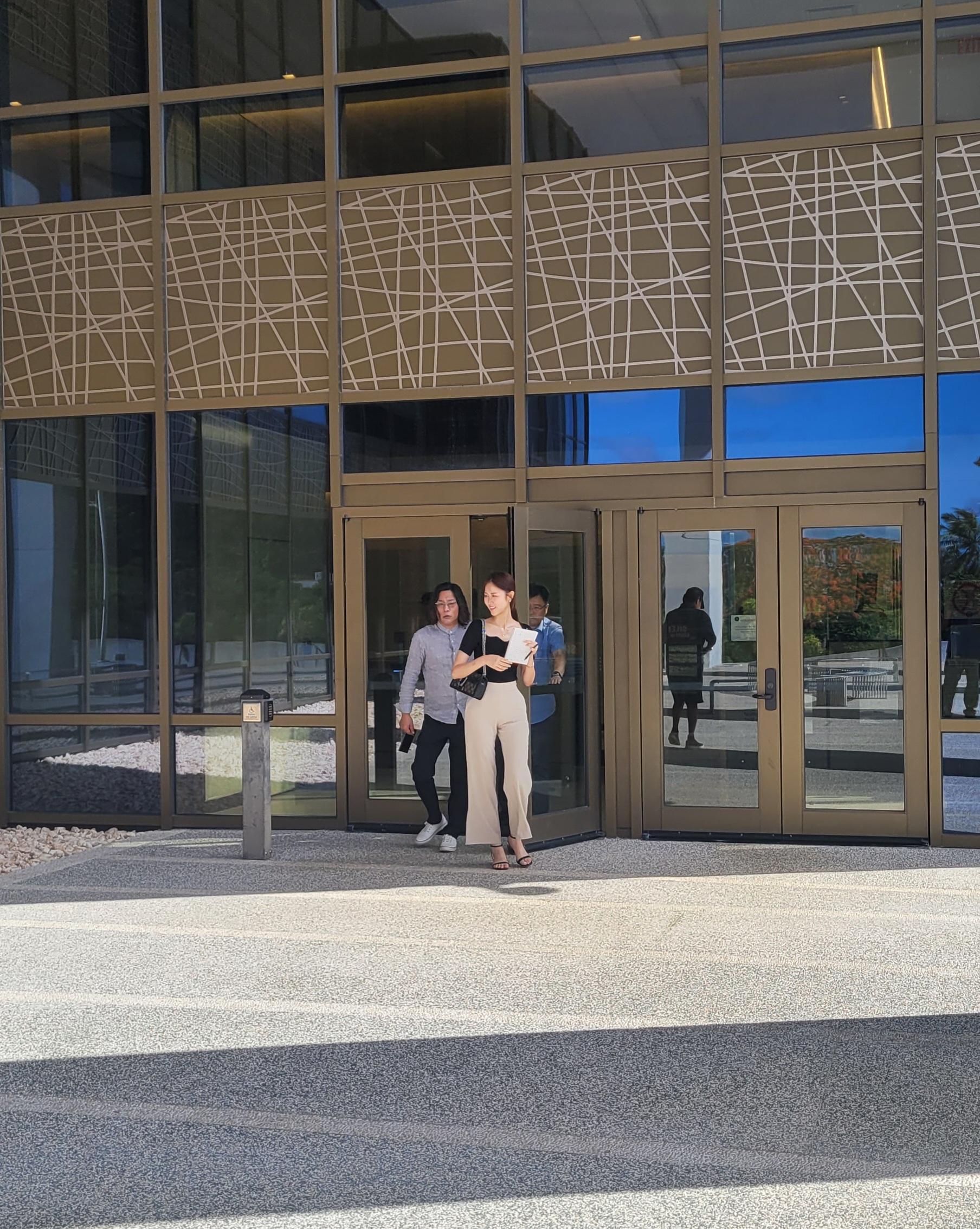  Kyunam Kim, left, of the IH Group and his interpreter and other companion exit the United States Courthouse on Tuesday after a hearing on the negotiations between Imperial Pacific International and the Commonwealth Casino Commission.