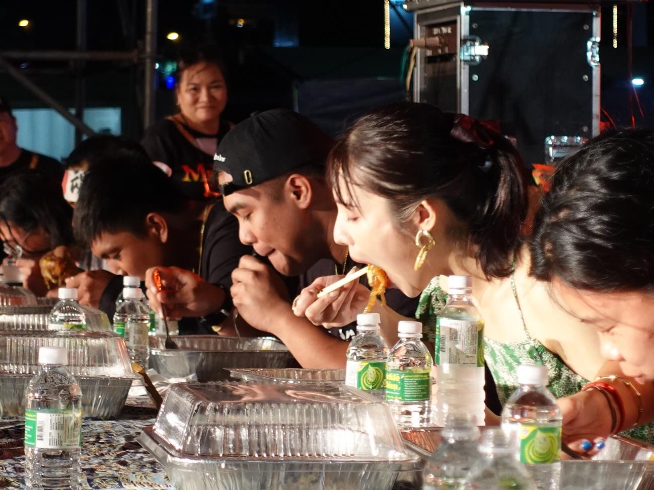 Japanese food fighter Sachiyo Masubuchi, second right, finishes 5 lbs. in 9:25 minutes in the Sukiyaki Eating Contest, besting nine other competitors on June 25, 2022, at the Taste of the Marianas International Food Festival & Beer Garden in Saipan.