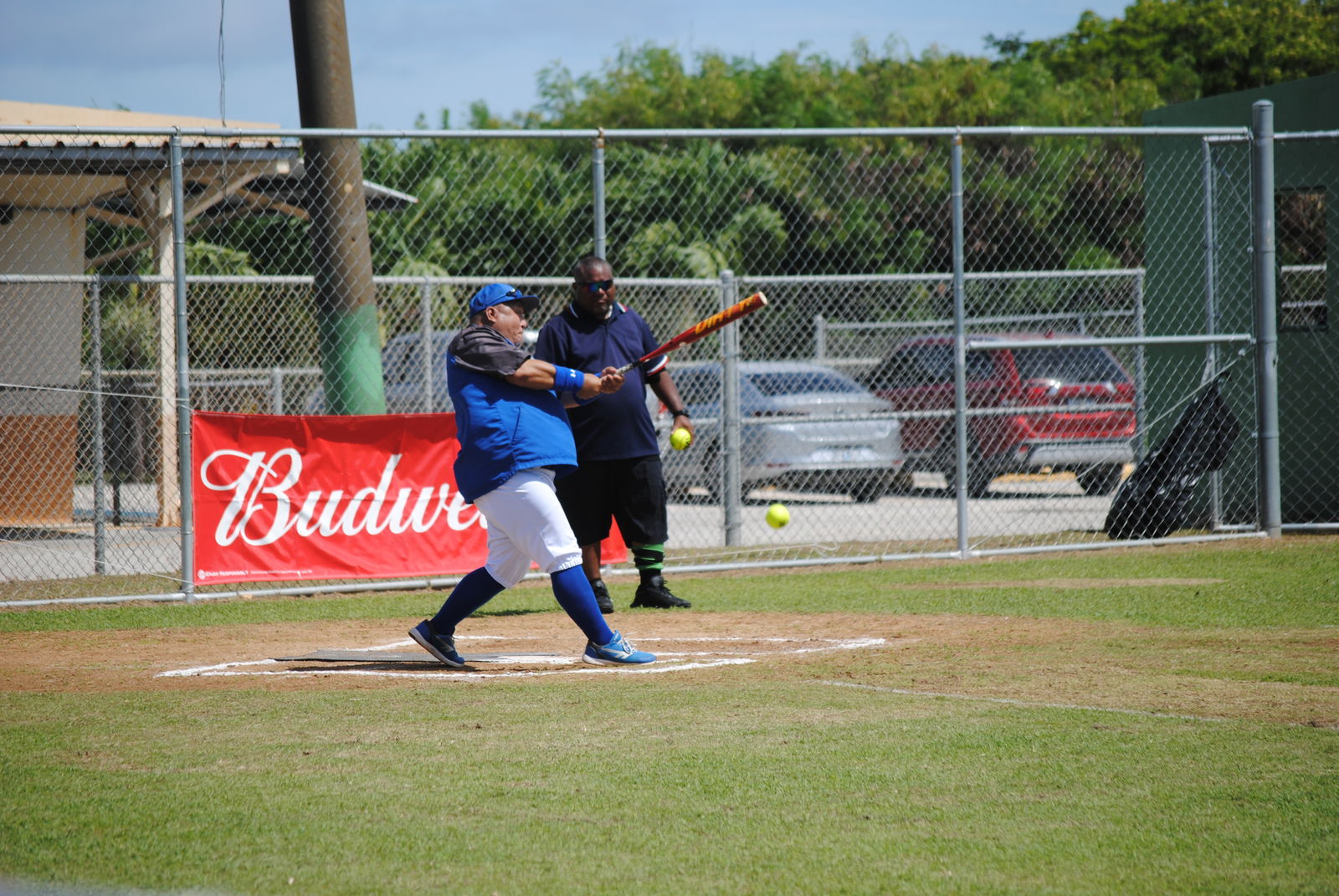 Man Amigos' Derron Flores connects the short grounder to reach first base safely during a 2022 Budweiser Belau Amateur Softball League game at the Dandan baseball field.