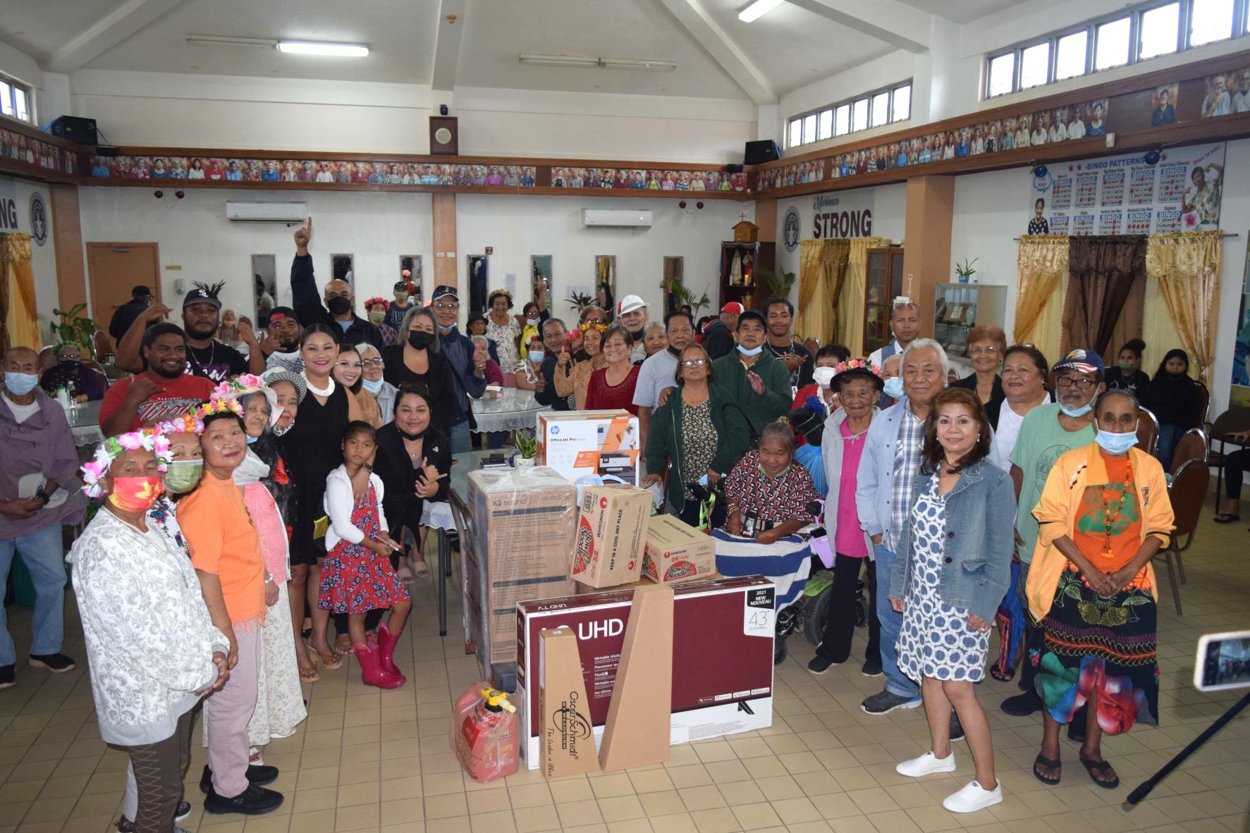 Senior citizens pose with Sen. Edith Delon Guerrero, Reps. Vicente Camacho, Corina Magofna and Denita Yangetmai beside their donated items at the Manamko' Center on Wednesday.