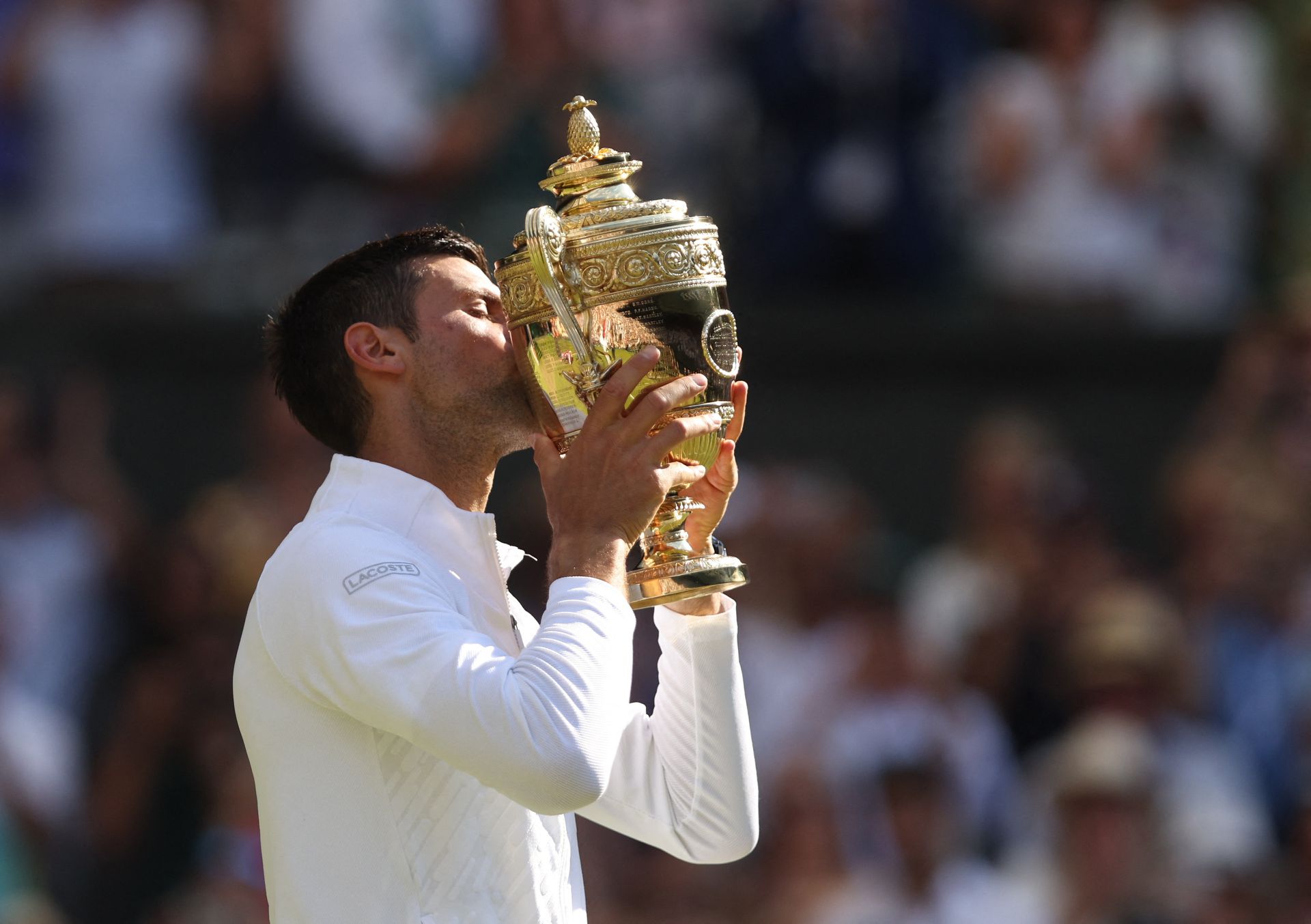 Serbia's Novak Djokovic celebrates with the trophy after winning the Wimbledon men's singles final against Australia's Nick Kyrgios at the All England Lawn Tennis and Croquet Club, London, Britain on July 10, 2022.