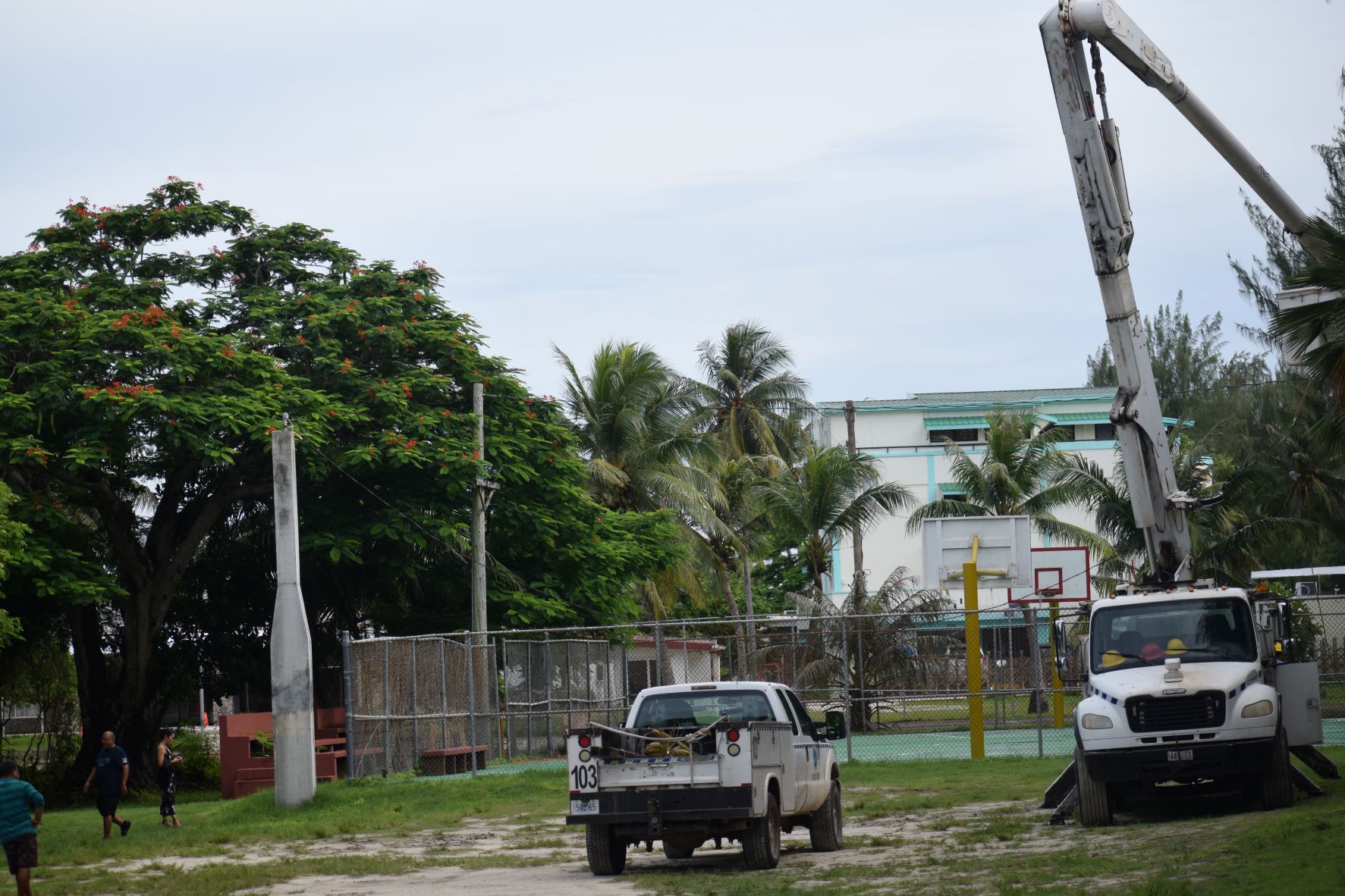 Commonwealth Utilities Corp. crewmembers install power cables, lights and weatherheads for the Laly Four basketball court on Wednesday.