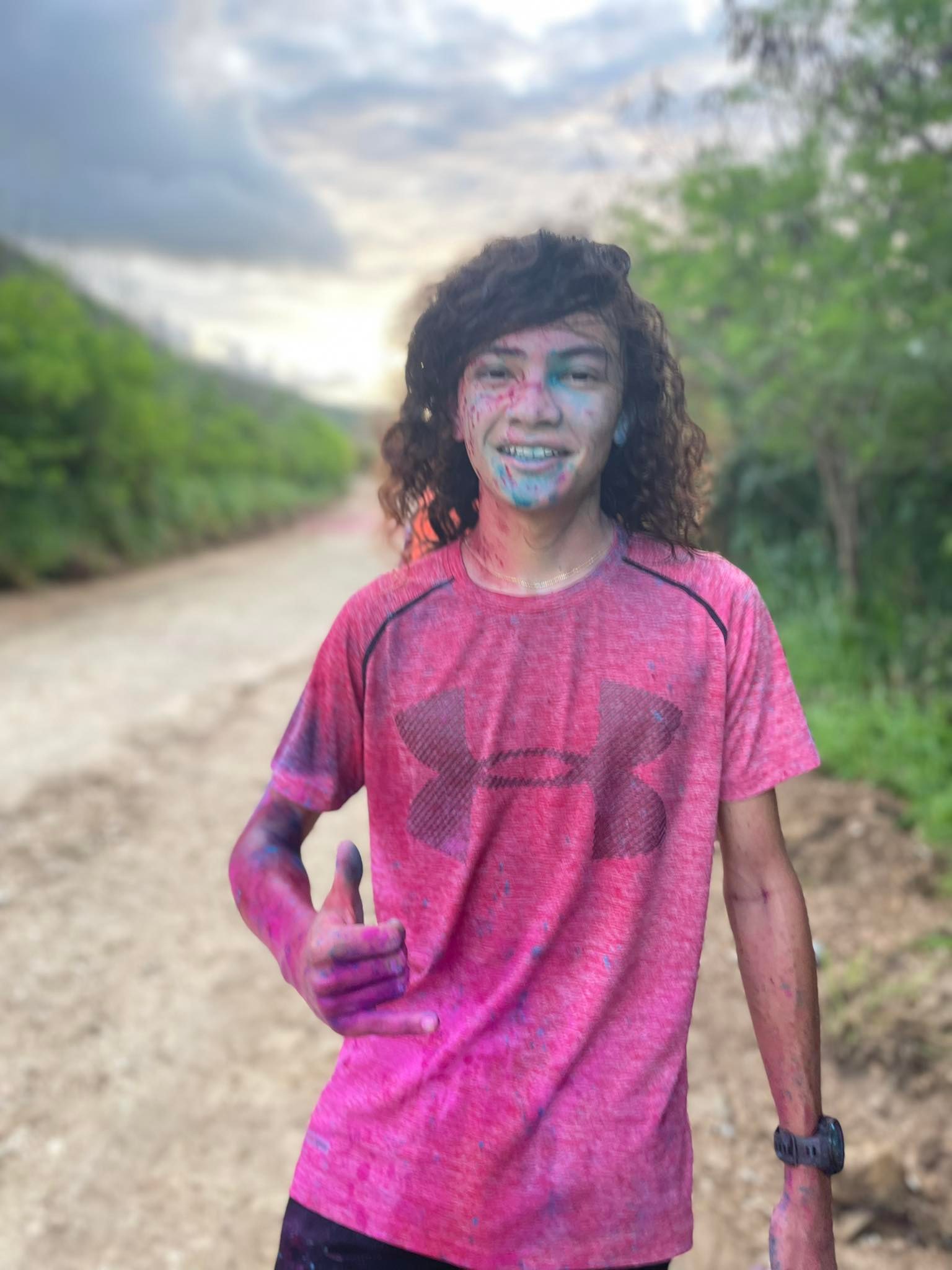 Rex Pixley poses for a photo after taking first place in the Acha'ikak Kulot 5K color run at Laolao Bay on Saturday.