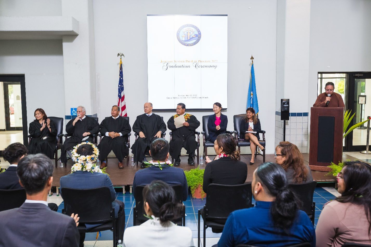 On stage, from left, District Court for the NMI Chief Judge Ramona V. Manglona,  Judge Kenneth L. Govendo, Justice Perry B. Inos, Justice John A. Manglona, Chief Justice Alexandro C. Castro, Professor Eun Hee Han, Dean Rose Cuison-Villazor,  and Director of Courts Sonia A. Camacho.
