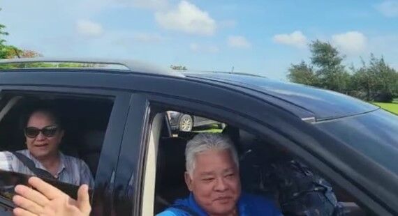 Lt. Gov. Arnold I. Palacios and second Lady Wella Palacios wave at  supporters on Airport Road after arriving from Hawaii on Saturday.