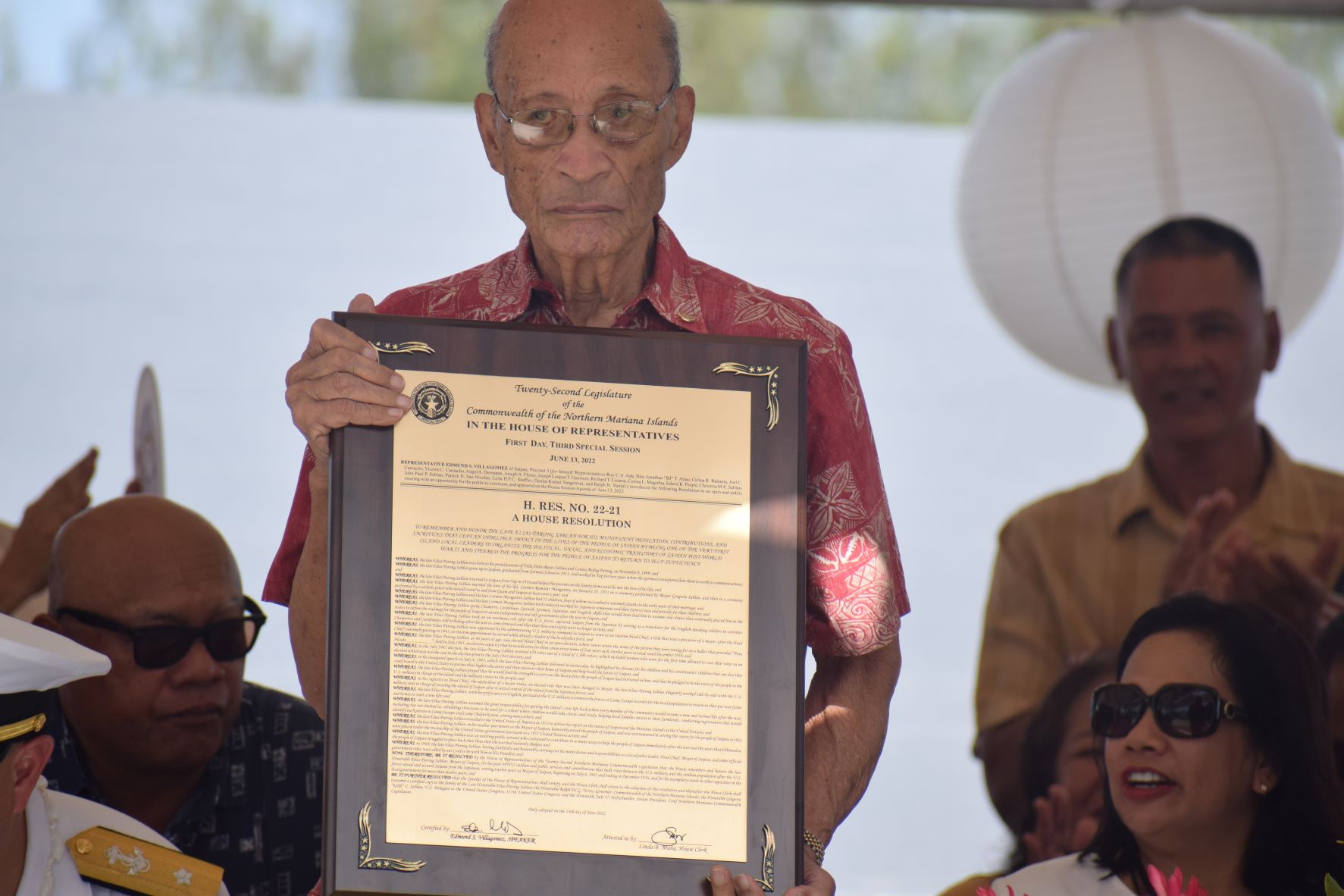 World War II survivor David "Uncle Dave" Mangarero Sablan holds the framed House Resolution 22-21 honoring his late father, Saipan's post-war mayor, Elias Parong Sablan.