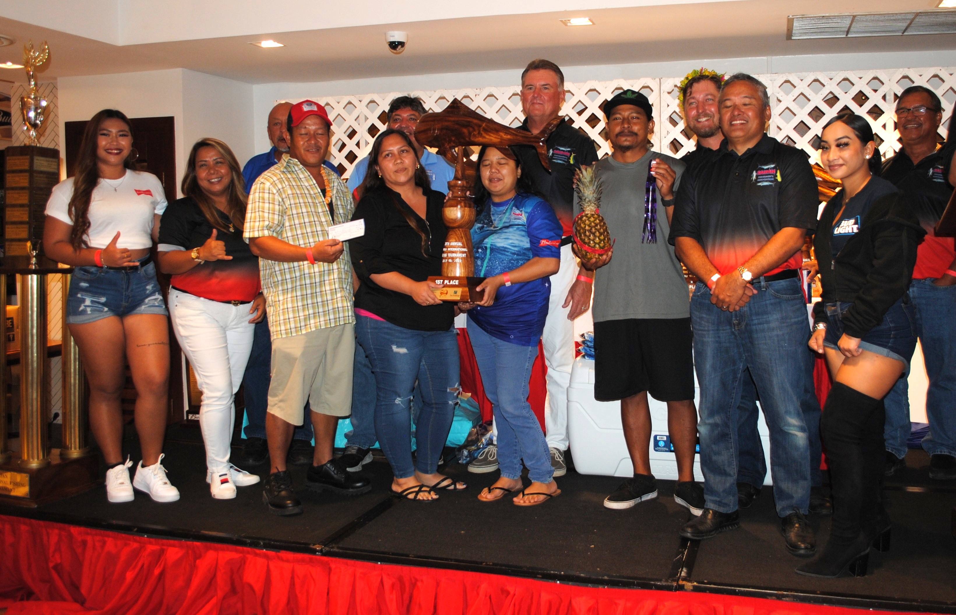 10-7 #2 crewmembers pose with their prizes, which include a pineapple, along with Saipan Fishermen’s Association members during the awards banquet of the 38th Saipan International Fishing Derby on Sunday at PIC.