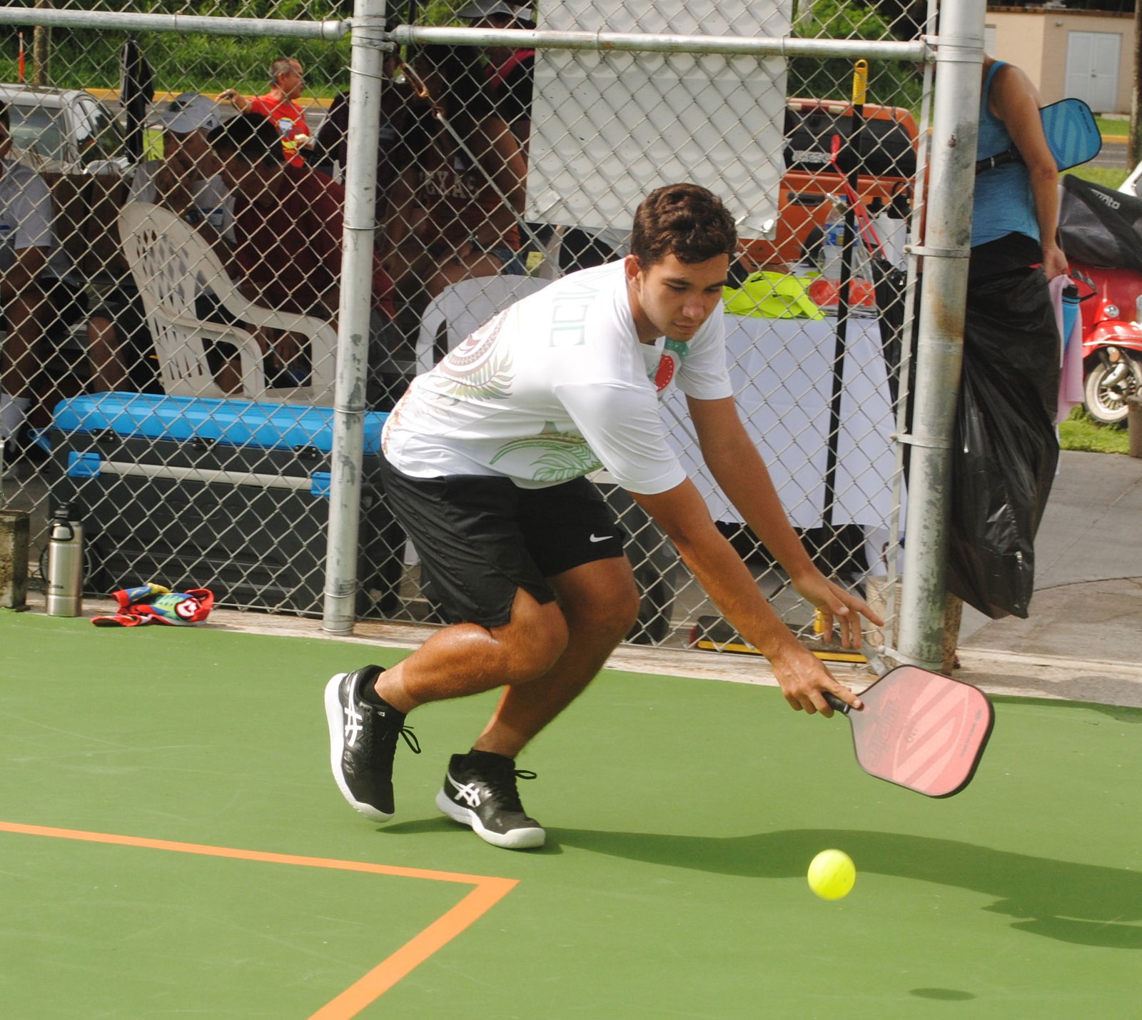 Robbie Schorr extends for the backhand return during the inaugural pickleball event at the newly striped court at American Memorial Park on Saturday.