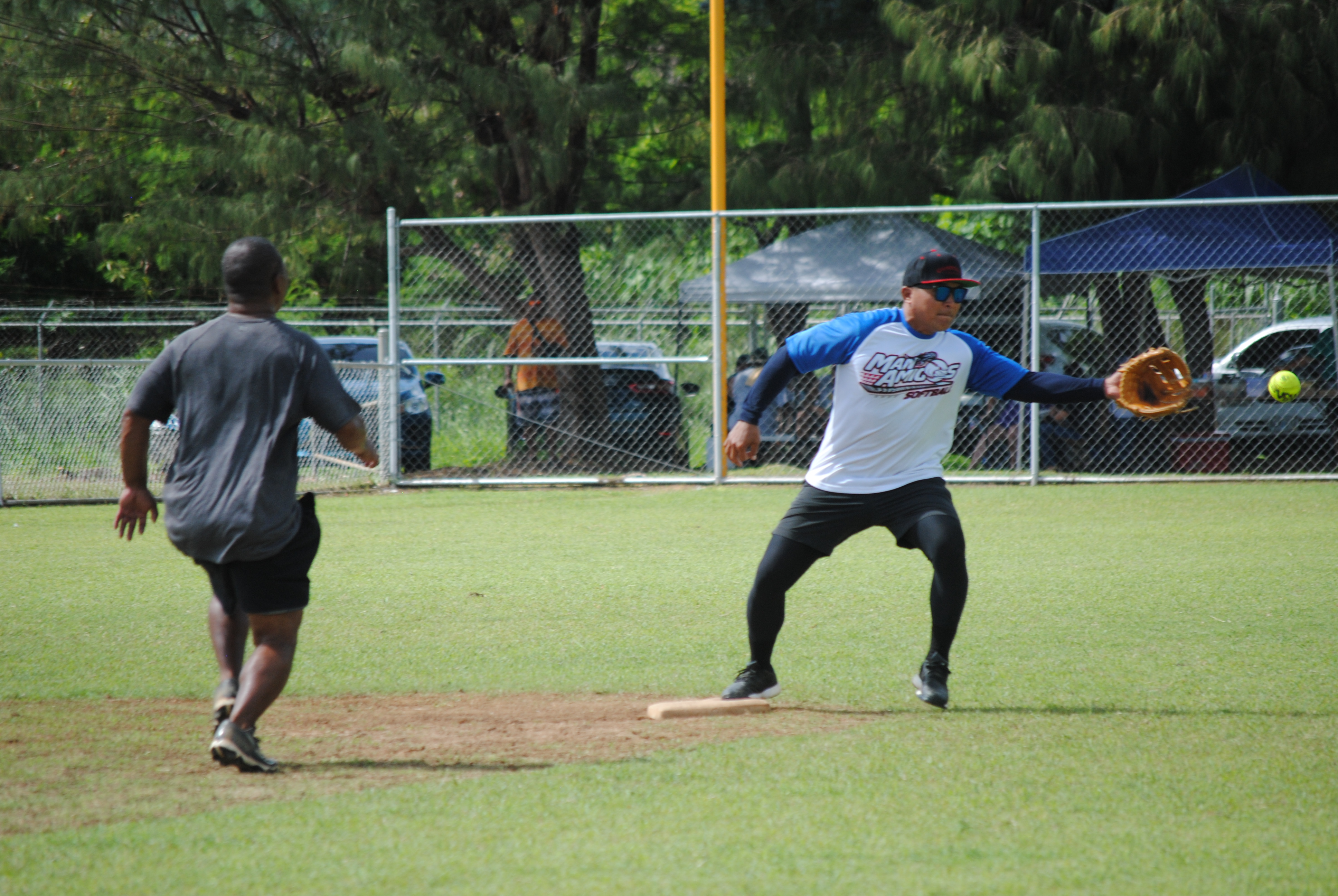 Man Amigos' Pete Sablan extends to catch the ball for an out on second base during a 2022 Budweiser Belau Amateur Softball League game Sunday at the Dandan baseball field.