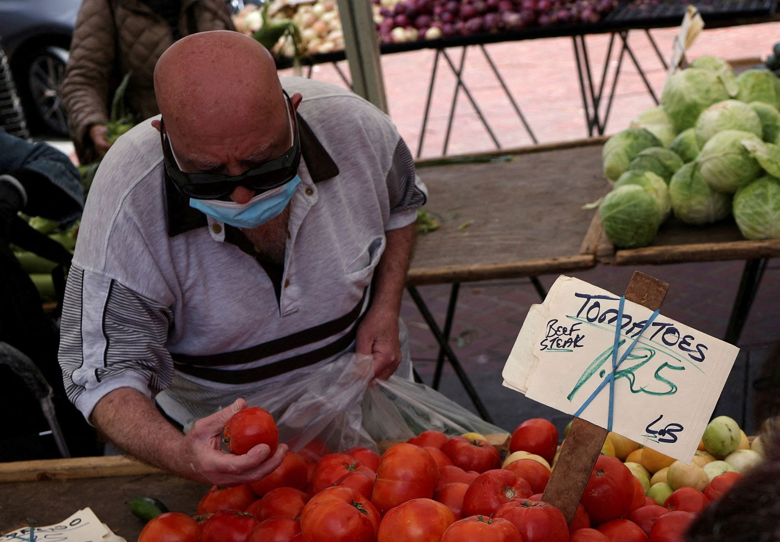 A resident buys tomatoes at a local market, in downtown San Francisco, California, July 13, 2022.