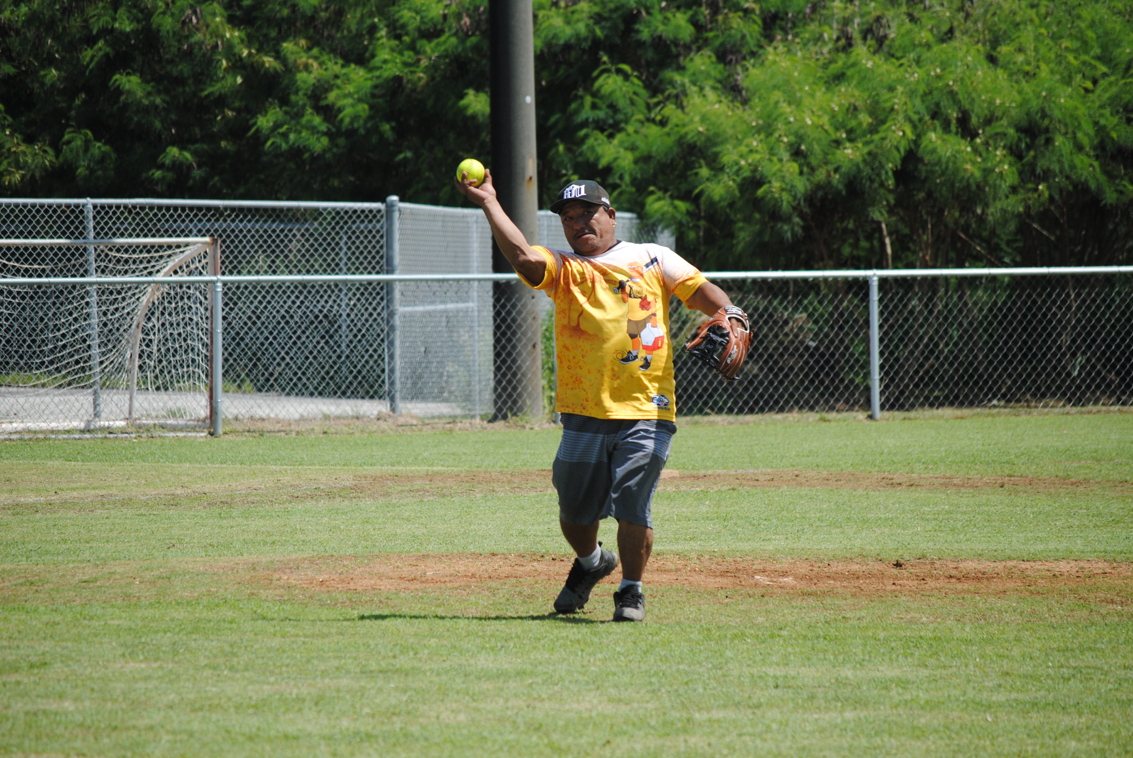 Hagu Lamun's pitcher Joe Celis throws to first base for the out during a 2022 Belau Amateur Softball League game Sunday at the Dandan baseball field.