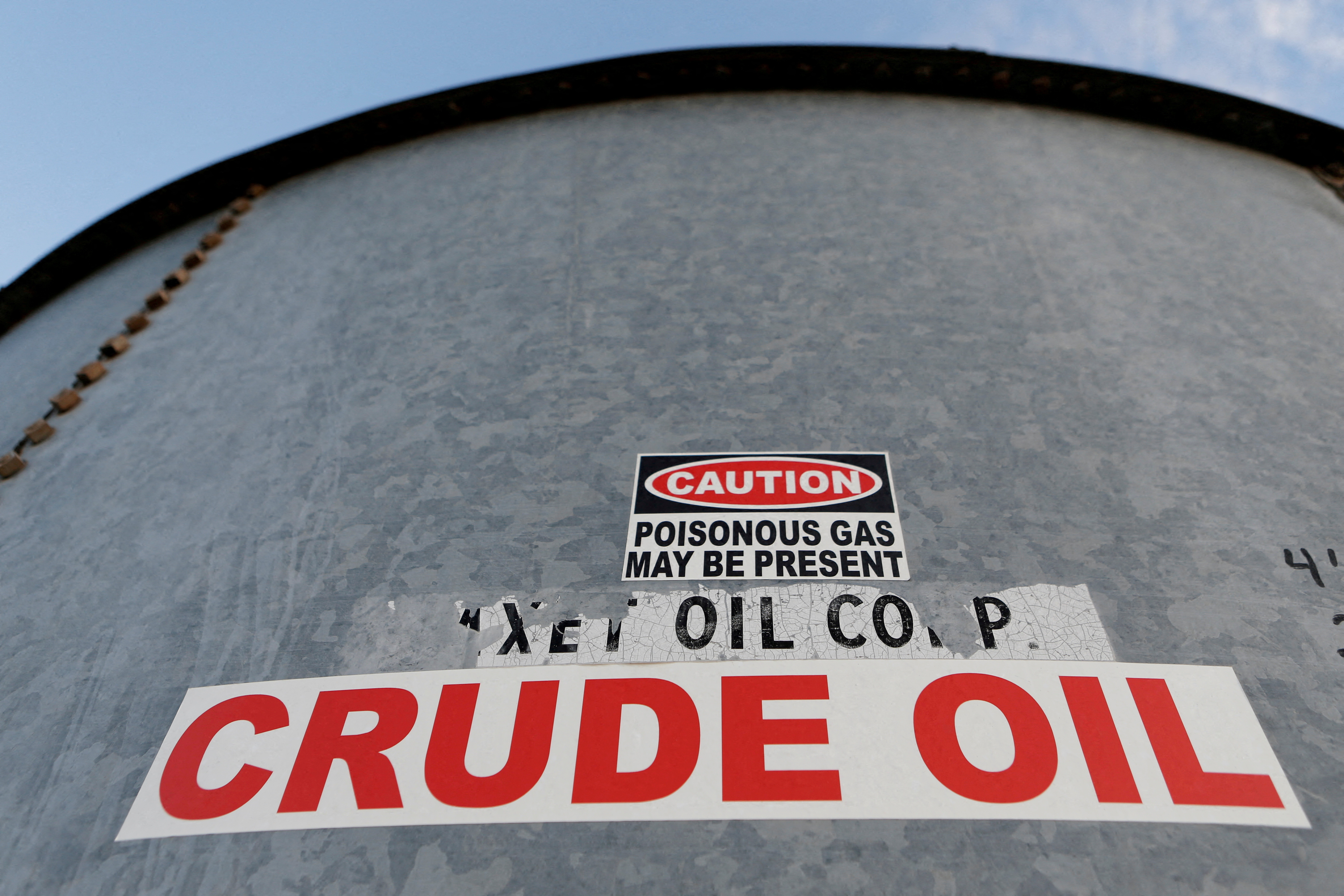 Sticker reads “crude oil” on the side of a storage tank in the Permian Basin in Mentone, Loving County, Texas, Nov. 22, 2019.