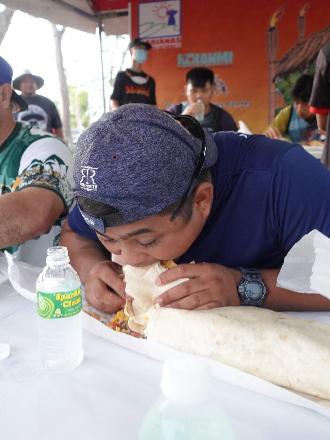 Raymond San Nicolas  demonstrates  his winning form  in the 5 Lb. Burritos Eating Contest on June 26, 2022, at the Taste of the Marianas International Food Festival & Beer Garden in Saipan. The contest was sponsored by The Hut.