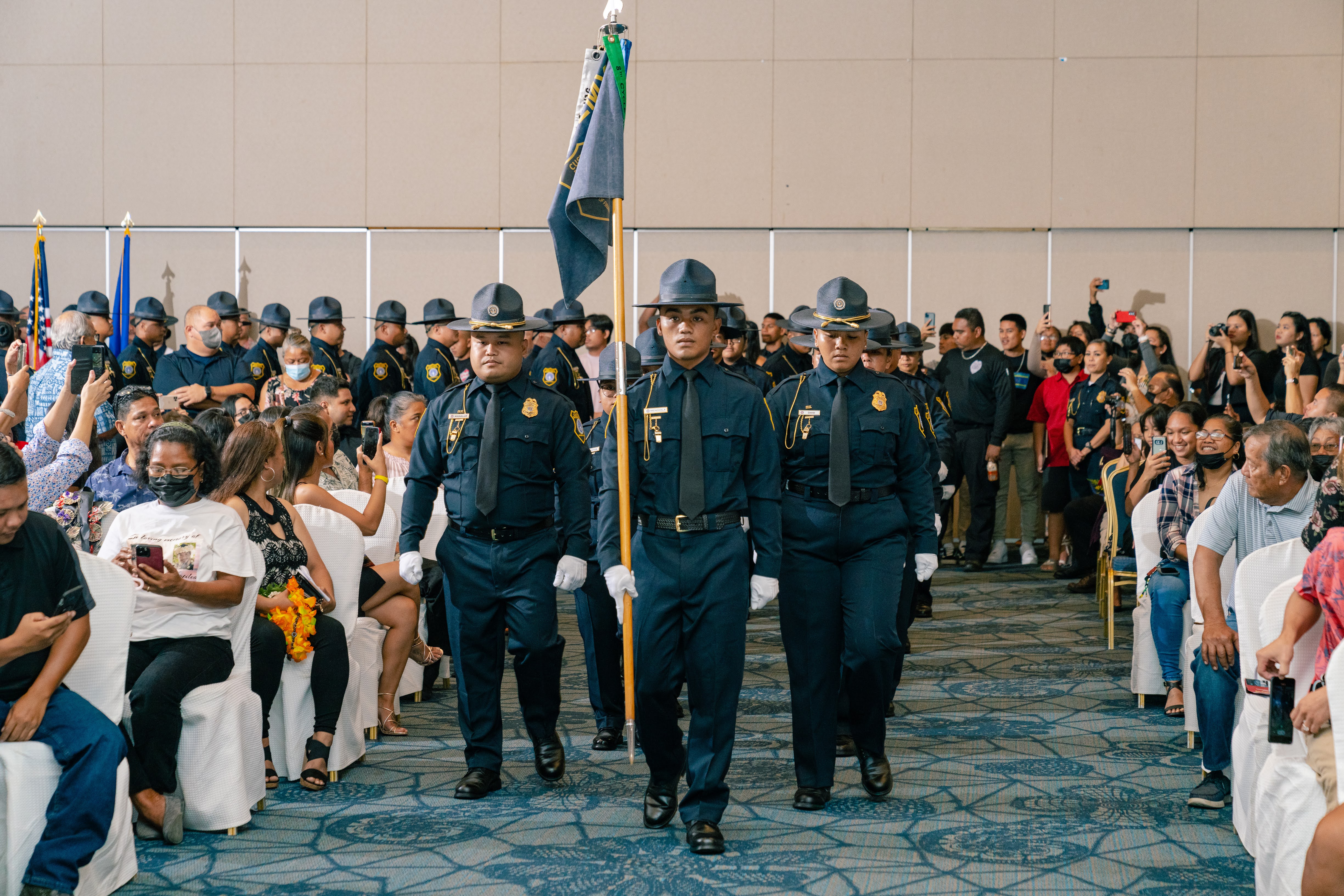 Graduates of the Division of Customs and Biosecurity 9th Cycle Academy march in formation into the graduation ceremony.