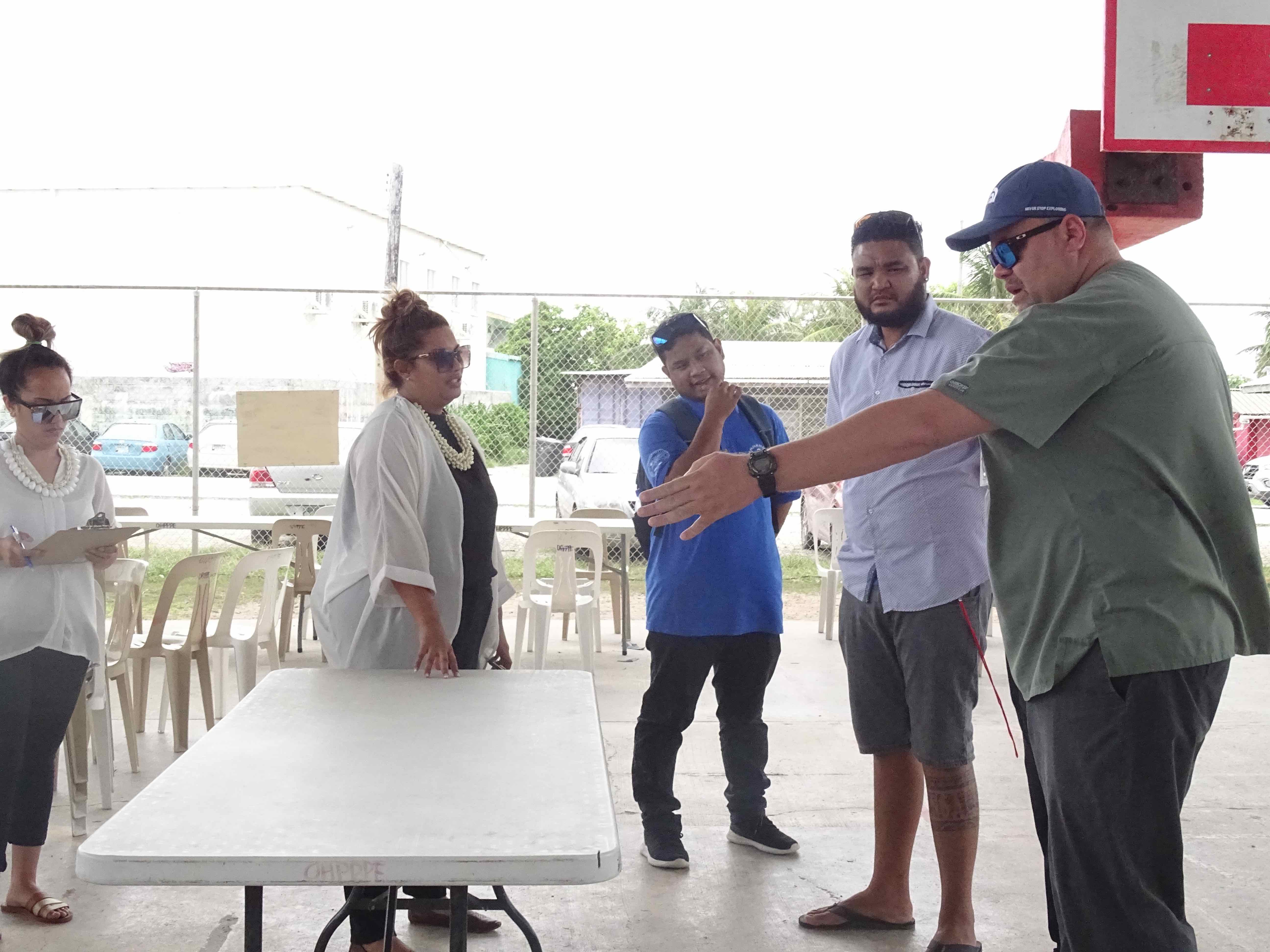 Marshall Islands Public Health Director Dr. Frank Underwood, right, leads a recent Ministry of Health and Human Services practice exercise for the use of gymnasiums to manage Covid cases once the country begins experiencing community transmission.