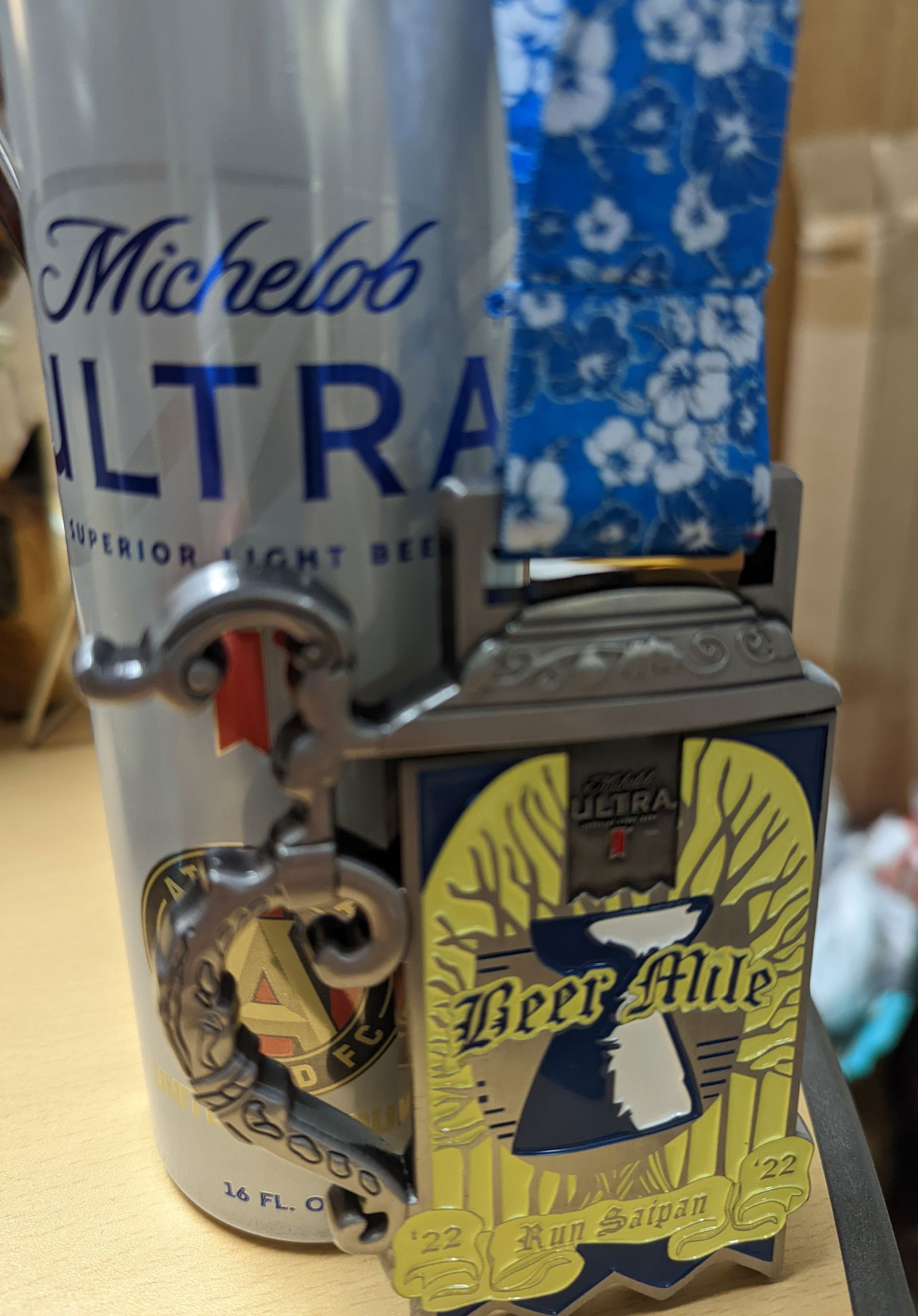 A medal with a Michelob Ultra bottle can.