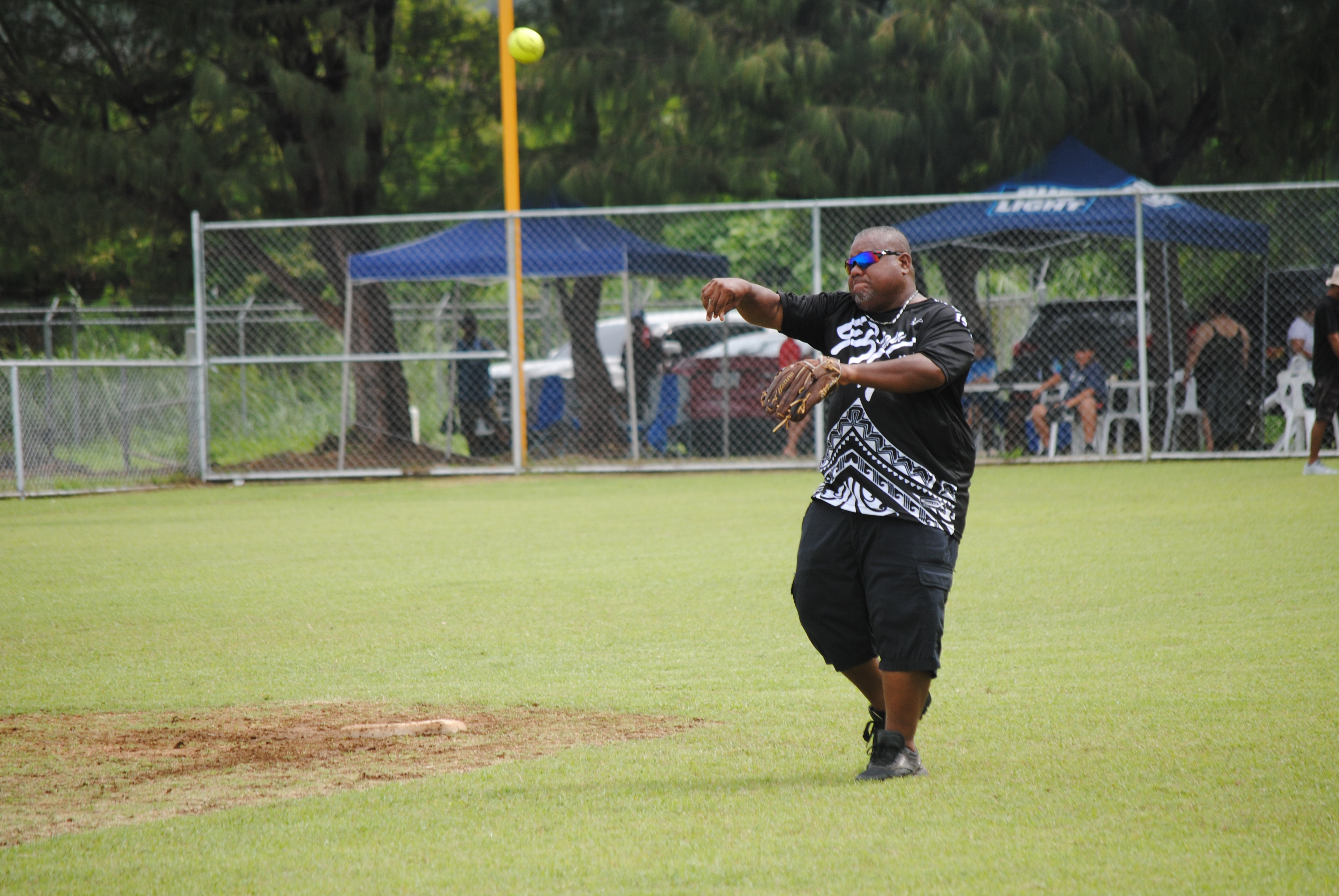 Asahi's Hector Efain throws to first base during a 2022 Budweiser Belau Amateur Softball League game Sunday at the Dandan baseball field.