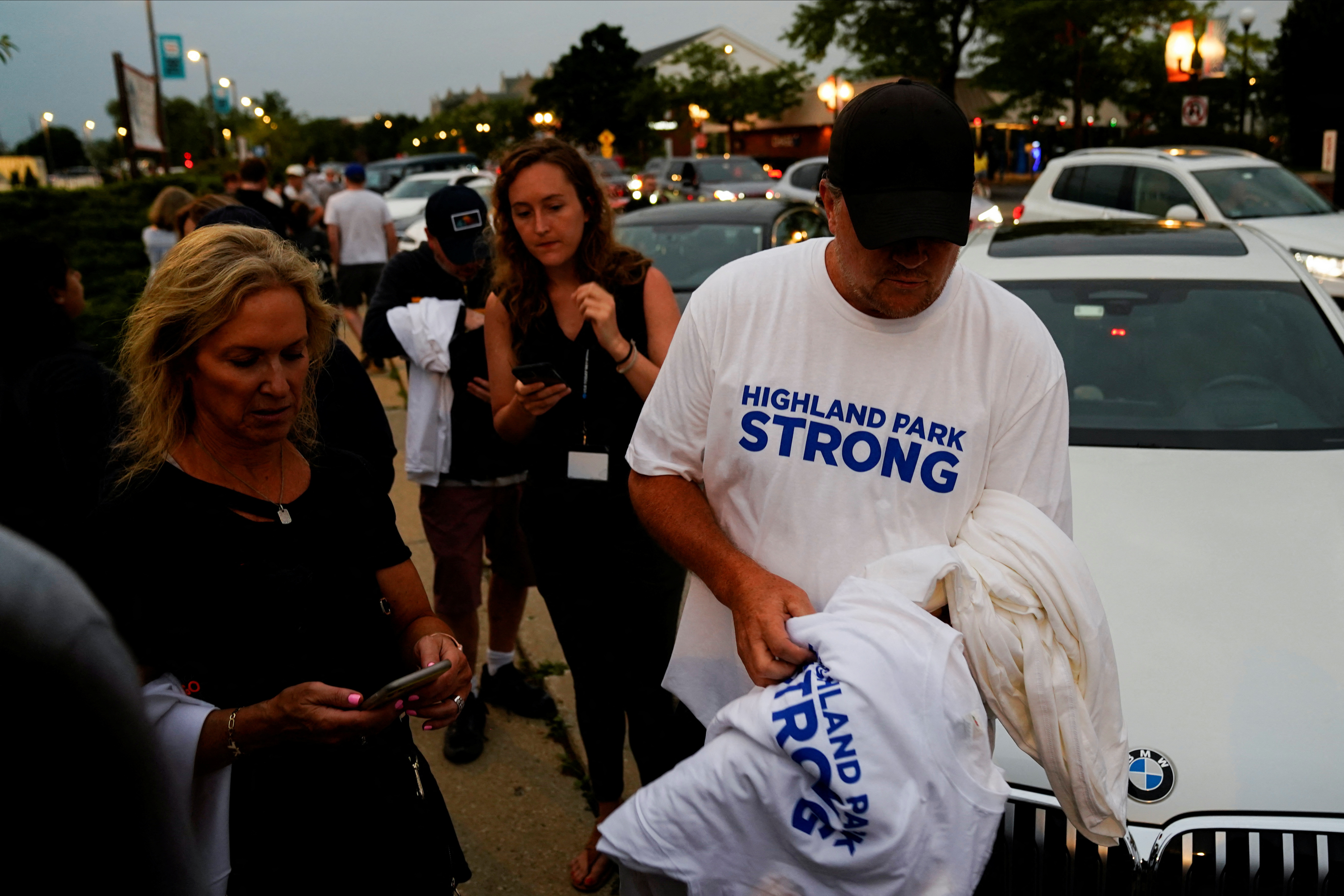 A man gives out shirts the day after a mass shooting at a Fourth of July parade in the Chicago suburb of Highland Park, Illinois, July 5, 2022.