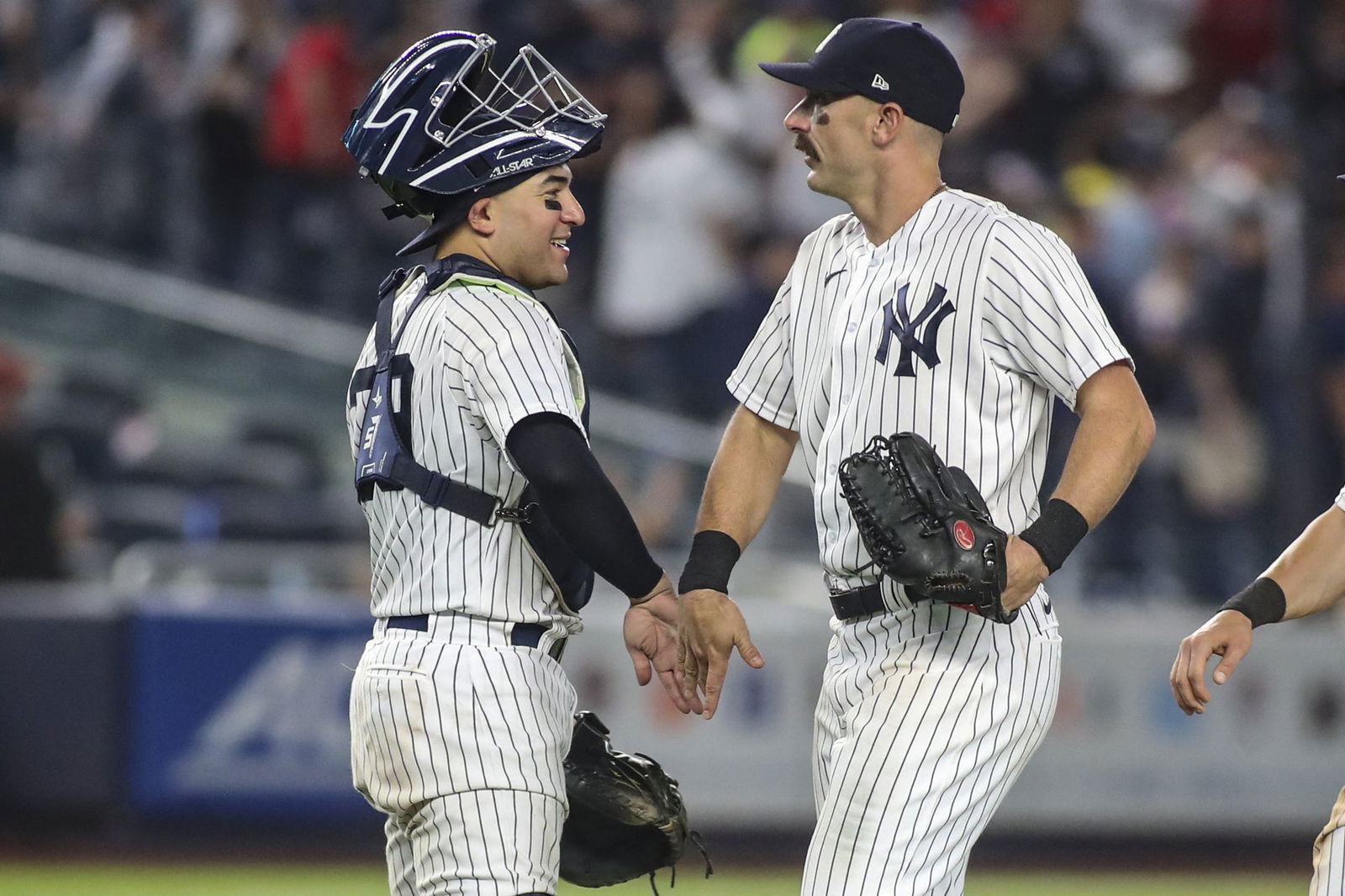 New York Yankees catcher Jose Trevino (39) and right fielder Matt Carpenter (24) congratulate each other after defeating the Boston Red Sox 14-1 at Yankee Stadium in the Bronx, New York on July 16, 2022.
