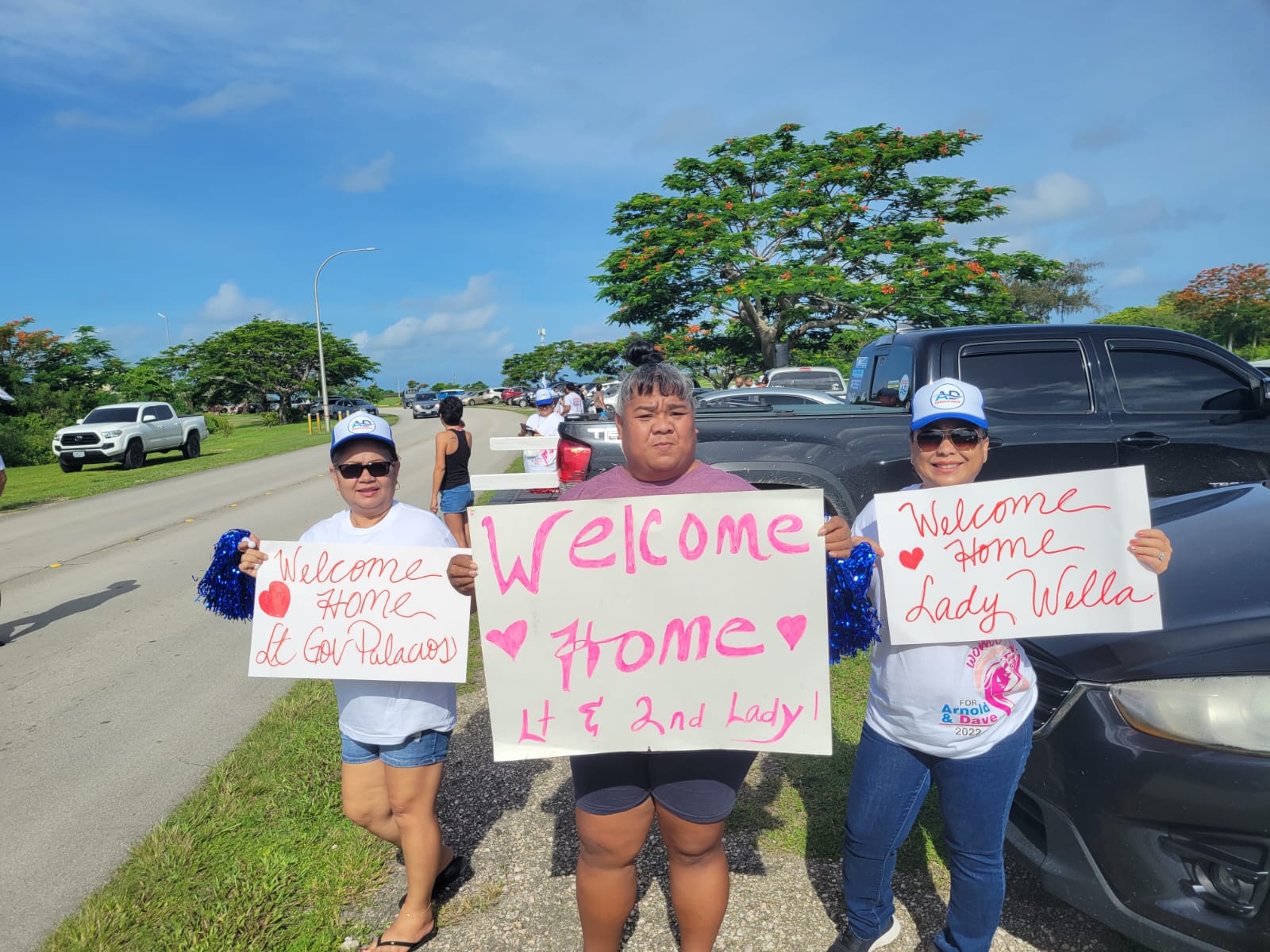 Supporters of independent gubernatorial candidate, Lt. Gov. Arnold I. Palacios, hold signs to welcome him home on Airport Road, Saturday.