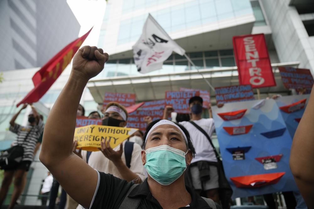 During a rally outside the Chinese consulate in Makati, Metro Manila on Tuesday, July 12, 2022, protesters shout slogans to mark the 6th anniversary of the issuance of the 2016 decision by an arbitration tribunal set up under the U.N. Convention of the Law of the Sea after the Philippines complained against China's increasingly aggressive actions in the disputed sea.