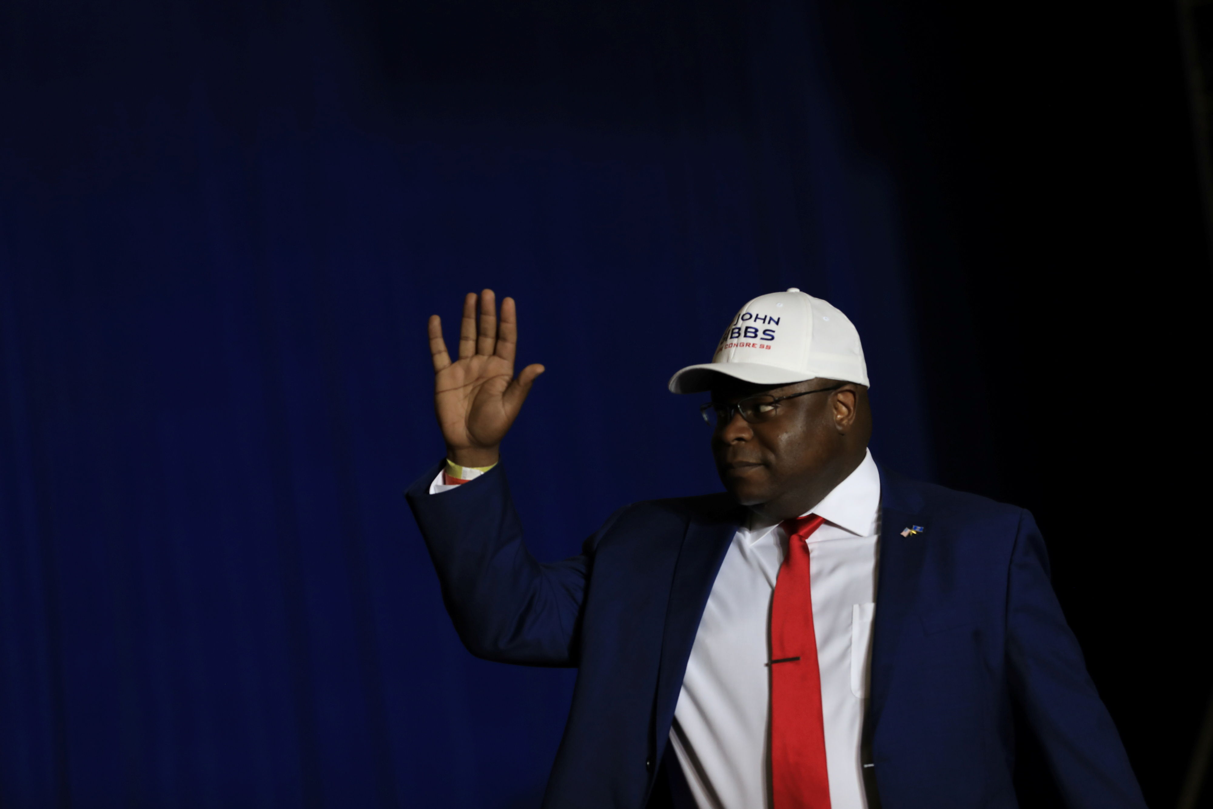 Candidate for Michigan's 3rd Congressional district John Gibbs waves to the crowd as he comes on stage during a rally held by former President Donald Trump in Washington Township, Michigan, D.C., April 2, 2022.