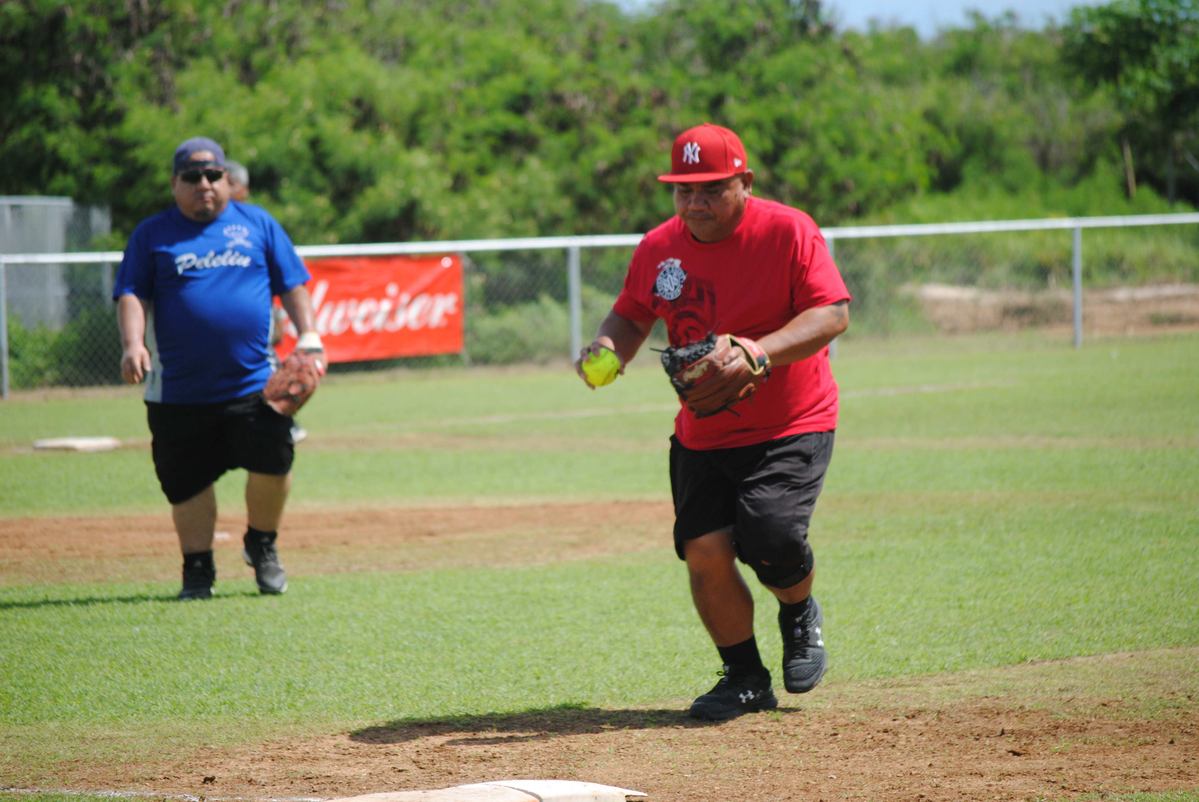 Peleliu's first baseman Jun Lizama runs toward first base for the out during a 2002 Belau Amateur Softball Association League game  at the Dandan baseball field.